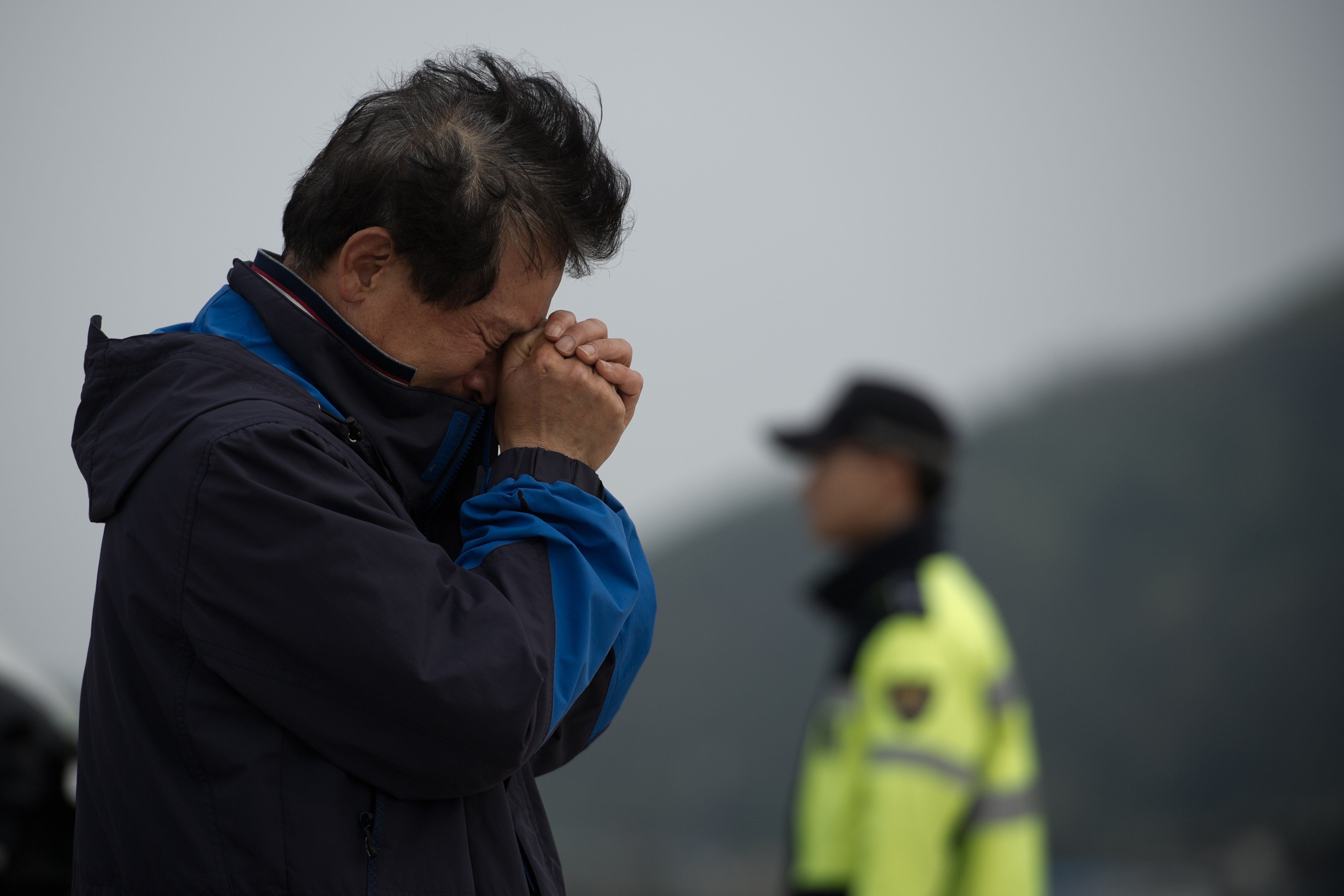 A relative weeps at an area where family members of victims of the South Korean ferry 'Sewol' are gathered, at Jindo harbour on April 21, 2014.