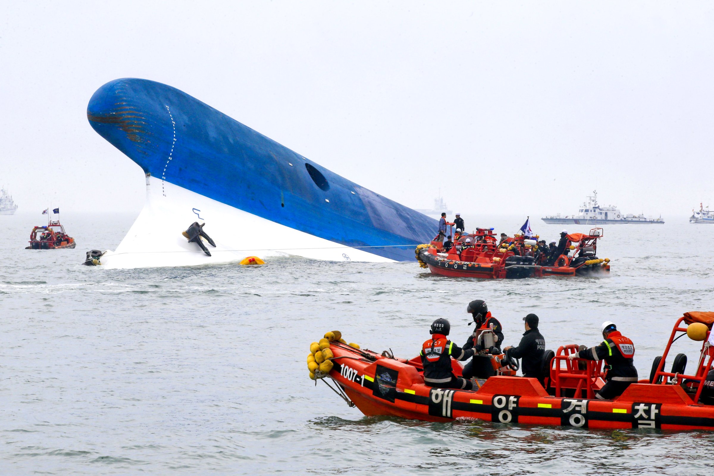 Coast guard members search for passengers near a South Korean ferry that capsized on its way to Jeju island from Incheon on April 16, 2014.