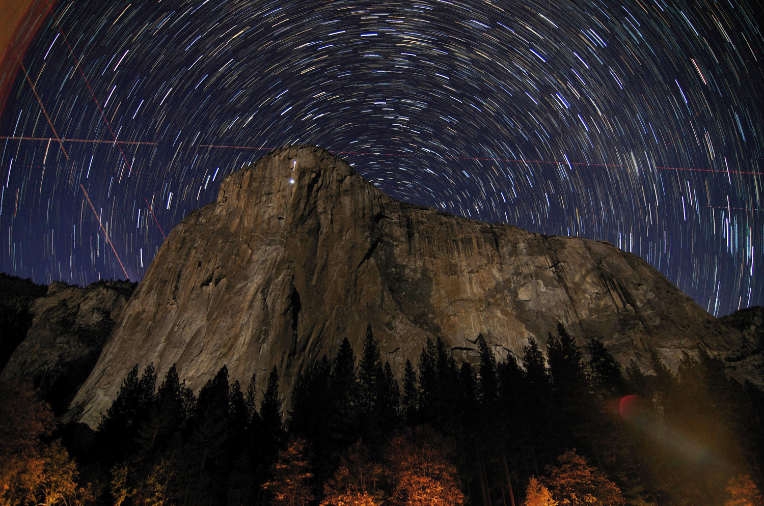 Star trails are visible over the granite face of El Capitan in Earth's Yosemite National Park in this image taken on November 8, 2013 and in March 2014. El Capitan hides the north celestial pole, which is at the center of all the star trails.