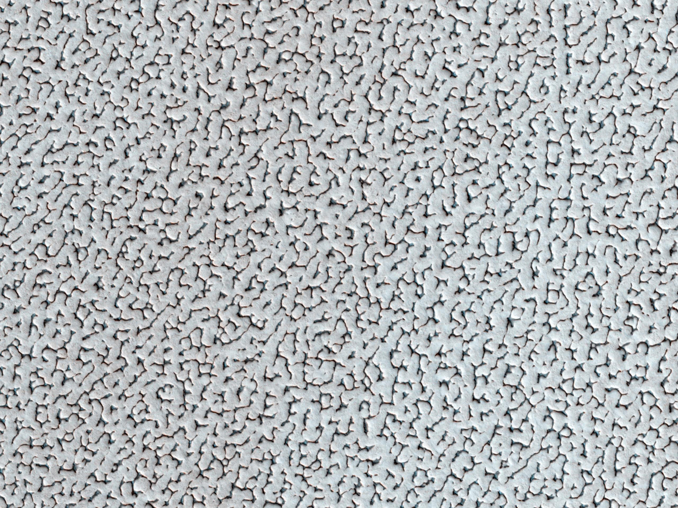 In this image released on March 5, 2014, the winter frosts are about to disappear on the North Pole of Mars, revealing the surface features of the ice. The ice cap is one of the smoothest, flattest places on Mars. This landscape continues for hundreds of kilometers in every direction with this same repeating pattern.
