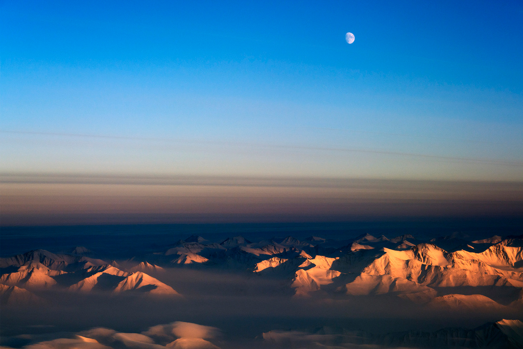This photo shows the moon over northeast Greenland, where a team of scientists returned to the Arctic with NASA’s P-3 aircraft to continue Operation IceBridge, a multi-year aerial survey of polar ice In March 2014.