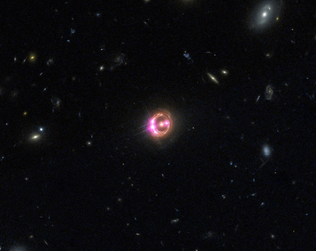 Multiple images of a distant quasar are visible in this combined view from NASA’s Chandra X-ray Observatory and the Hubble Space Telescope.