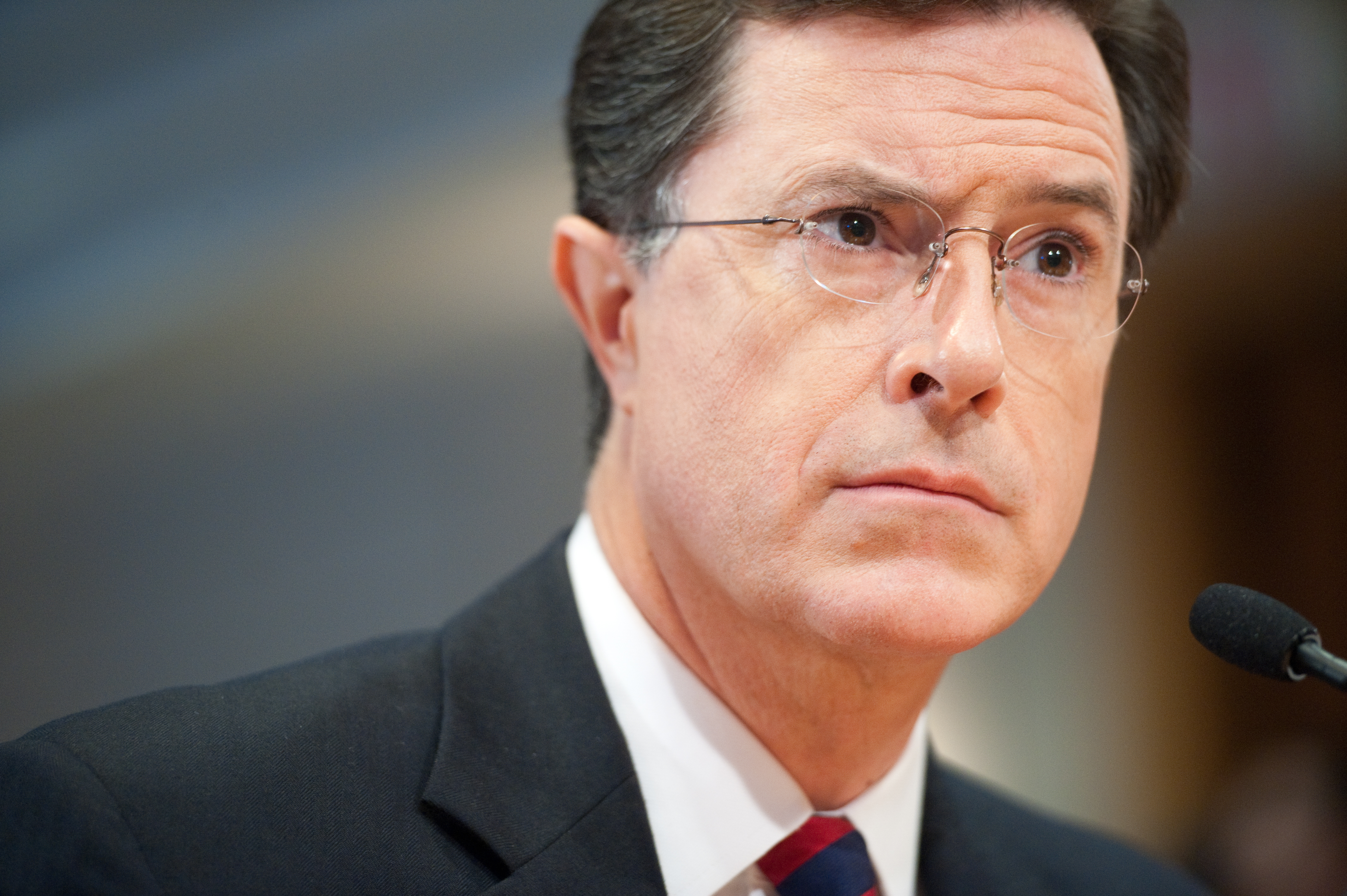 Stephen Colbert listens to a commissioner as he appears at a hearing at the Federal Election Commission in Washington, D.C. to discuss his request to form a Political Action Committee on June 30, 2011.