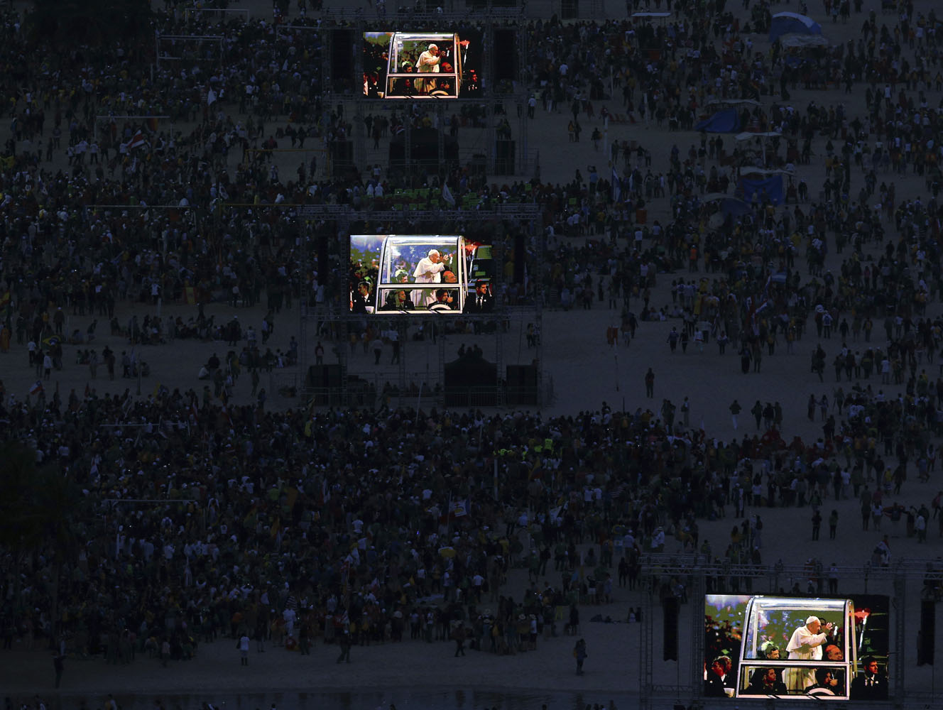 Pope Francis is projected on screens at Copacabana beach in Rio de Janeiro