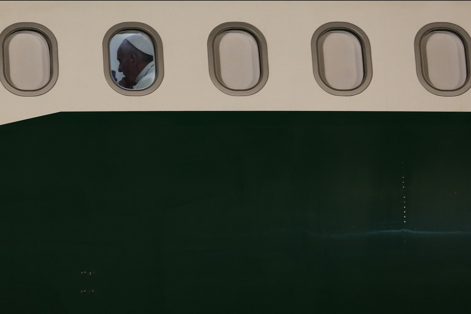 Pope Francis is pictured inside his plane before departing from Rio de Janeiro at Galeao Air Base