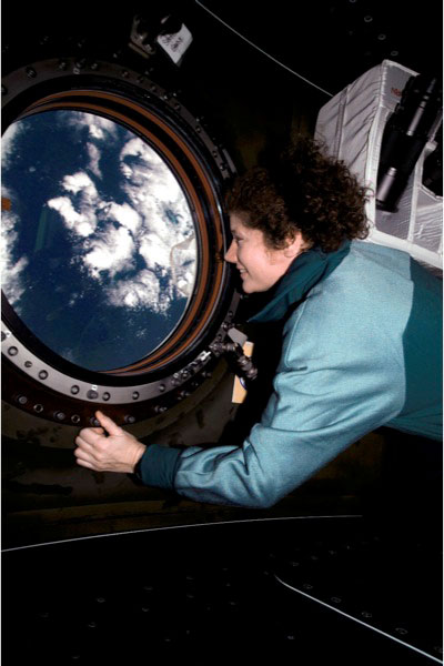 NASA Astronaut Susan J. Helms, flight engineer, views the topography of a point on Earth from the nadir window in the U.S. Laboratory / Destiny module of the International Space Station (ISS), on March 31, 2001. Helms is now a three-star lieutenant general in the United States Air Force.