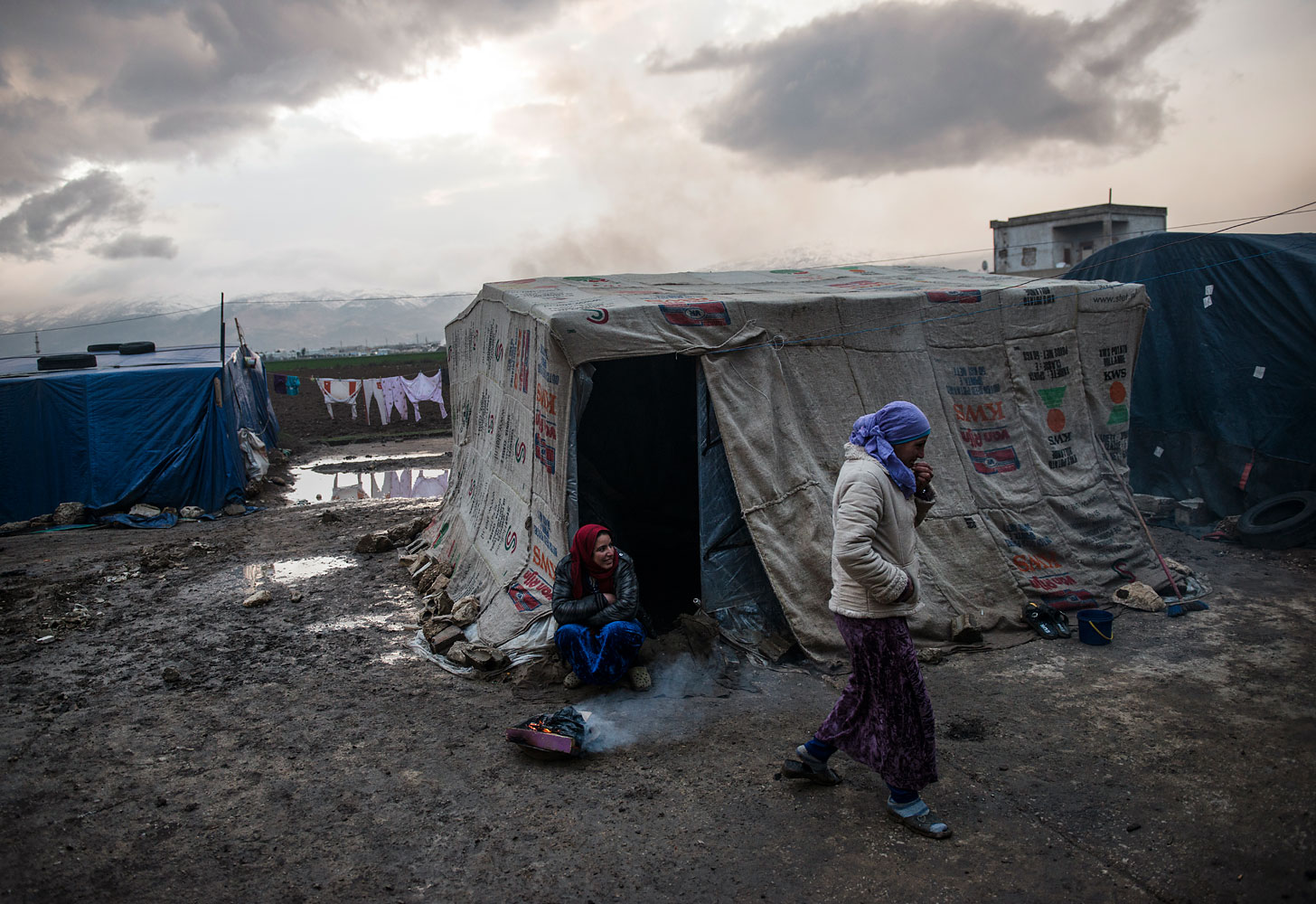 Seventy families live by the shell of an abandoned onion-processing factory, trudging through the mud in flip-flops. Many had to bail water from their tents after a rainstorm. They pay between US$50 and US$200 a month to live here in Faida, Bekaa Valley.