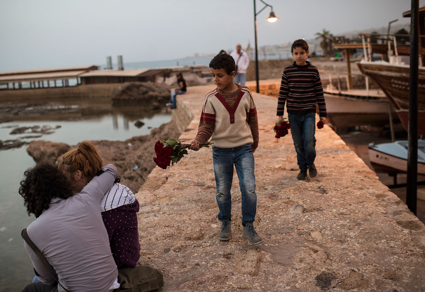 Manhal, aged nine, and Ahmed, 11, brothers from the northern Syrian city of Aleppo, sell flowers by the sea in Byblos. They go to school by day, and work all evening. Their older brother doesn’t go to school at all. “I would if I could,” says Mohammed. “But who would help my father with the rent?”