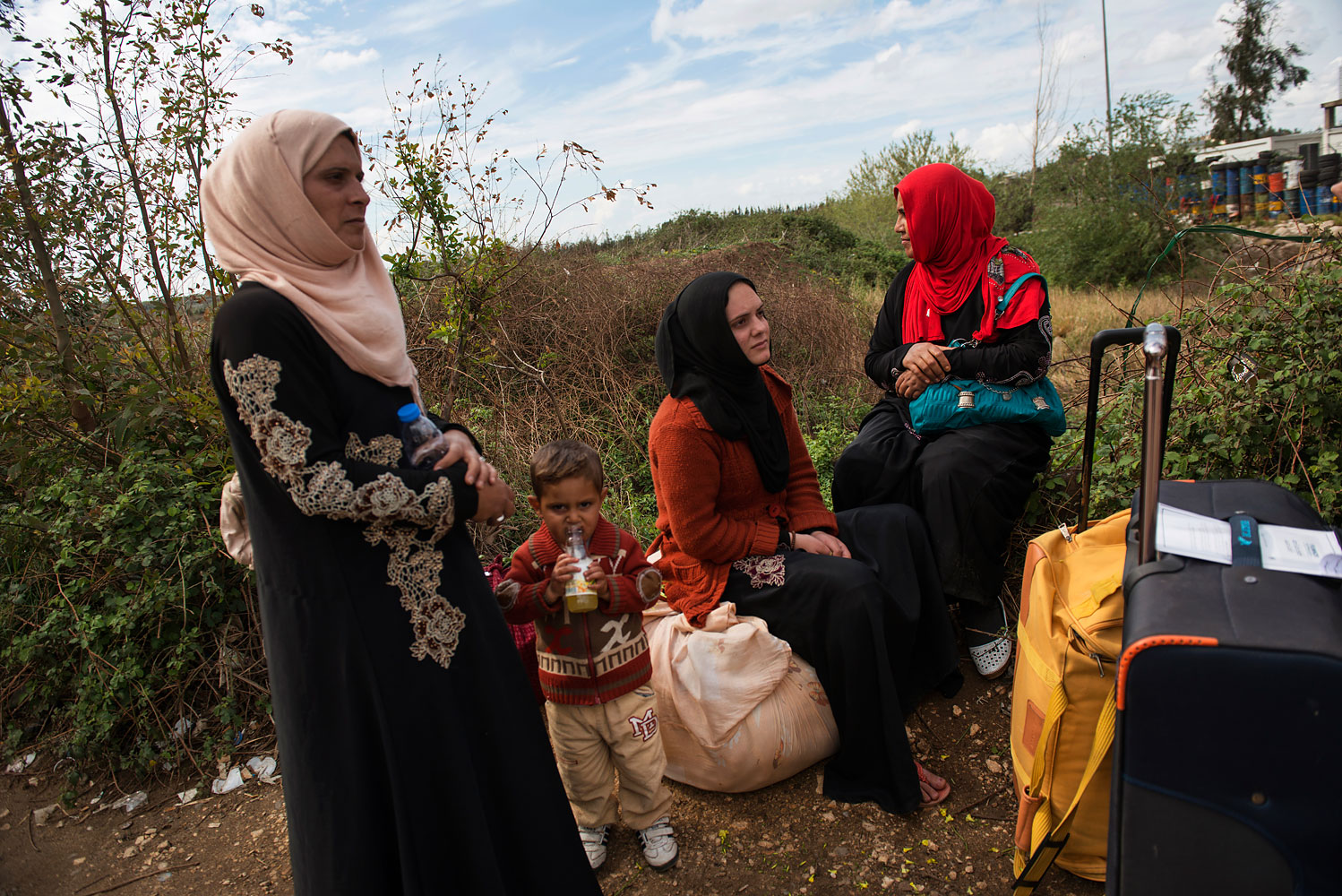 Amar and Masrine, their sister-in-law Nahlah and her son Mazen, wait to cross the border in the Lebanese town of Aboudiyeh. Their bags are all they have left. “What saddens me is not losing things, but losing people,” says Amar. “My other sister-in-law was shot a year-and-a-half ago.”