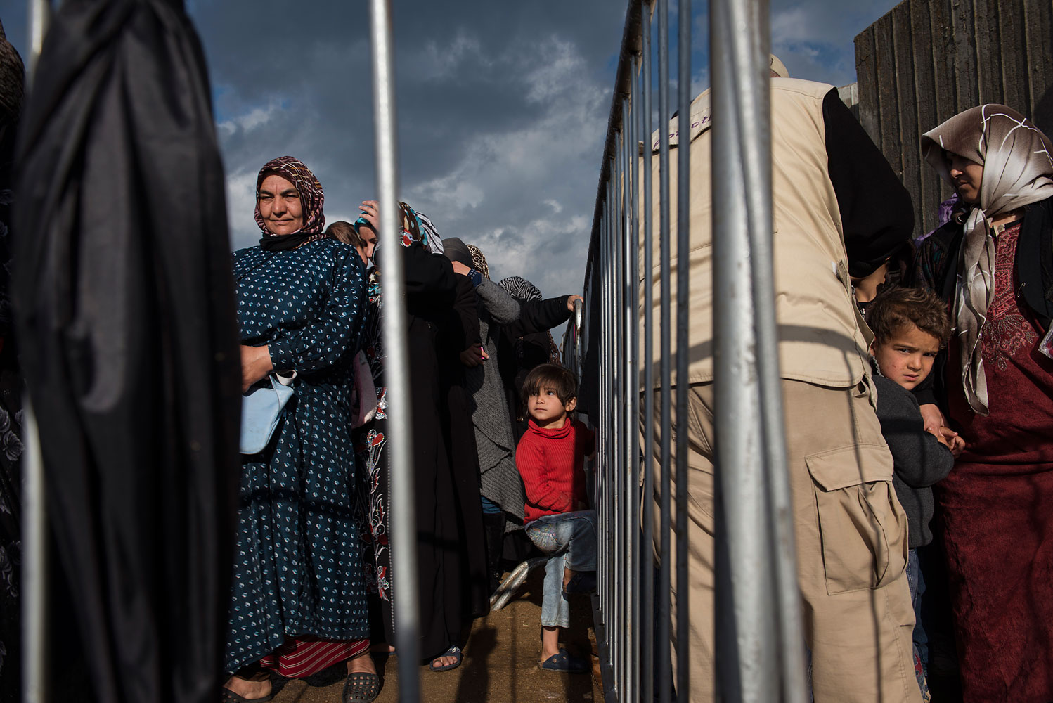 Syrian refugees line up to register or renew their registration at the UNHCR compound in Tripoli, in North Lebanon, March 11, 2014.