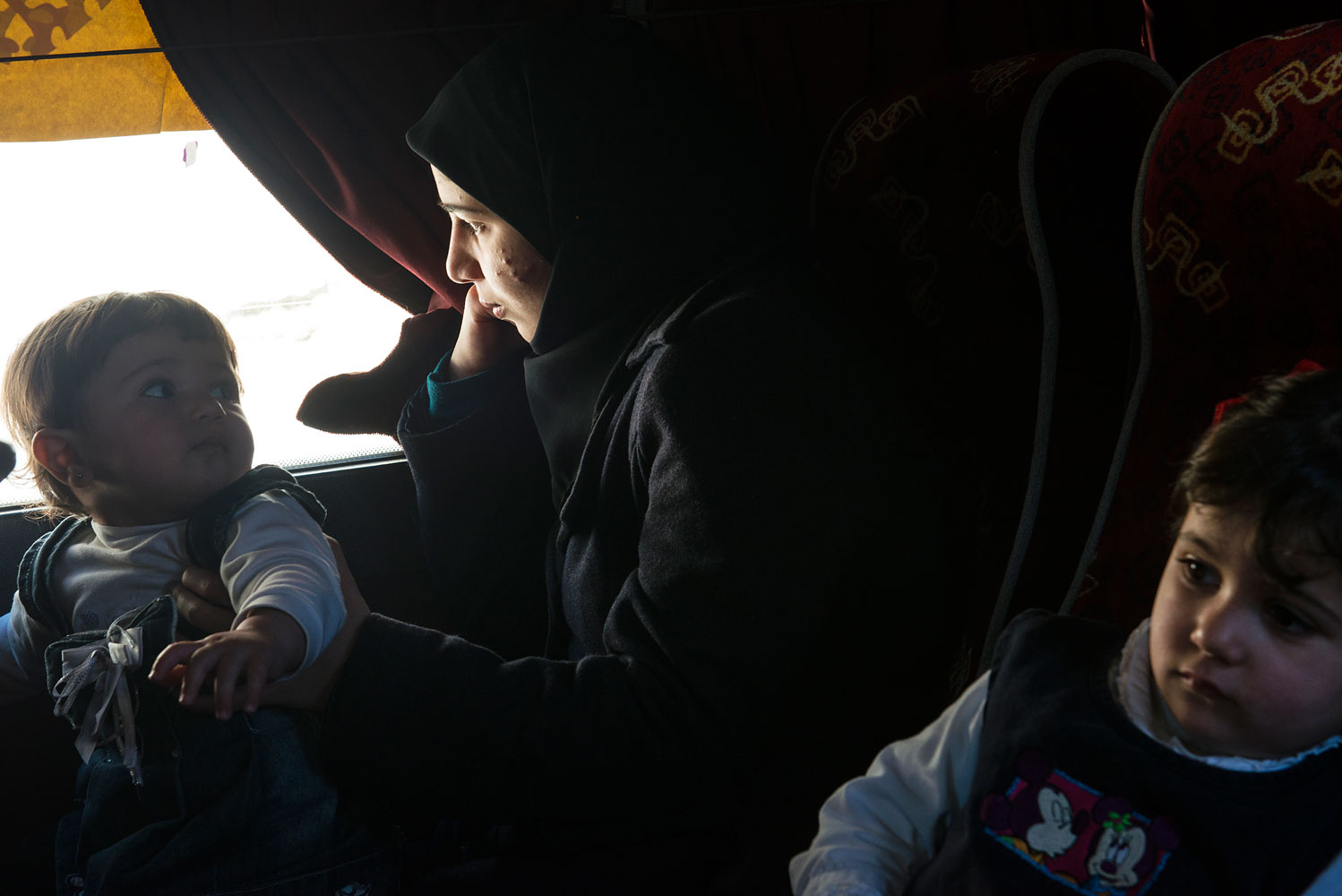 Syrian refugees from the southern border areas gather in the village of Blat, in Marjaayoun, to be bussed to Tyre to register with UNHCR after arriving in Lebanon, March 5, 2014.