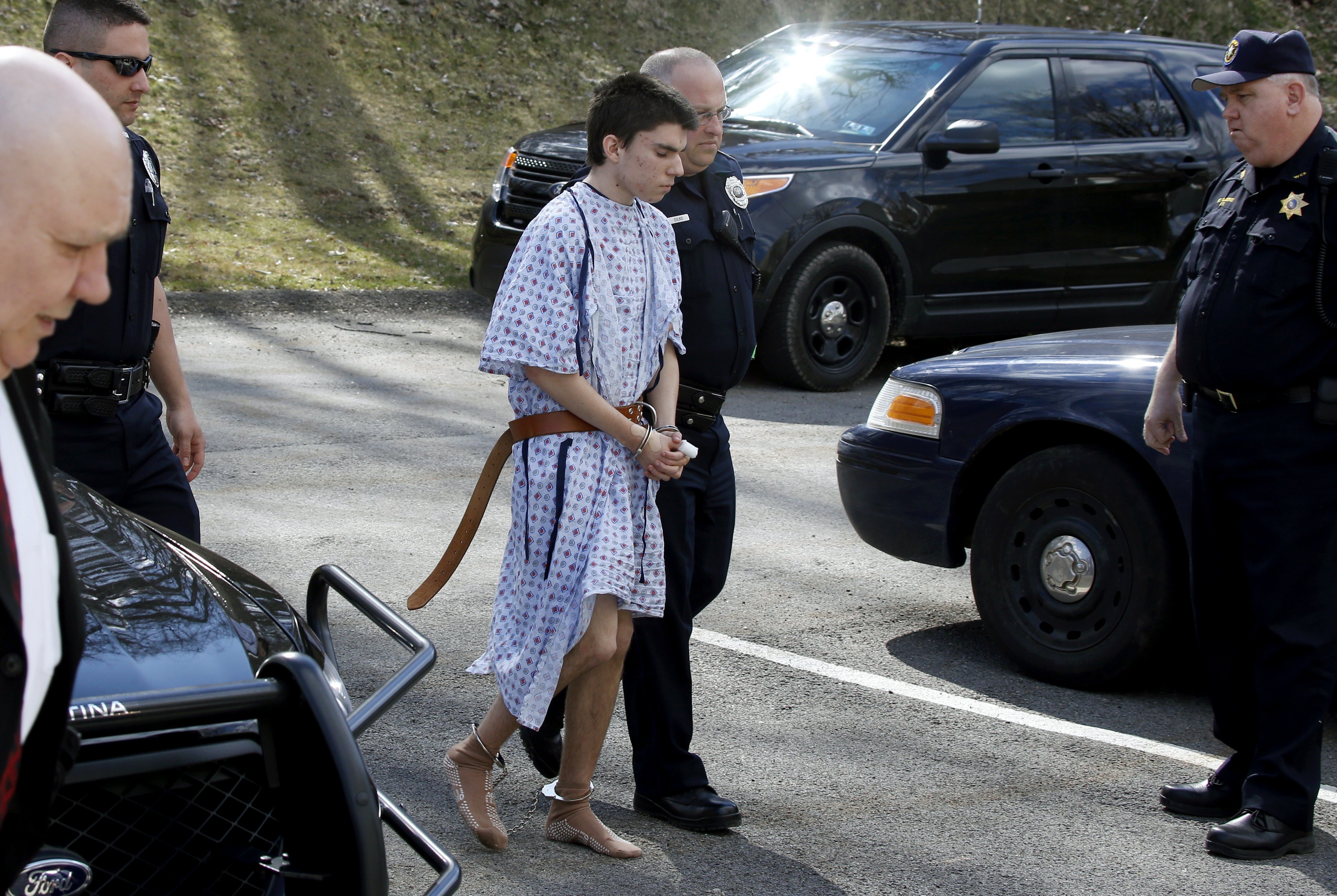 Alex Hribal, the suspect in the multiple stabbings at the Franklin Regional High School in Murrysville, Pa., is escorted by police to a district magistrate to be arraigned in Export, Pa., April 9, 2014. (Keith Srakocic—AP)