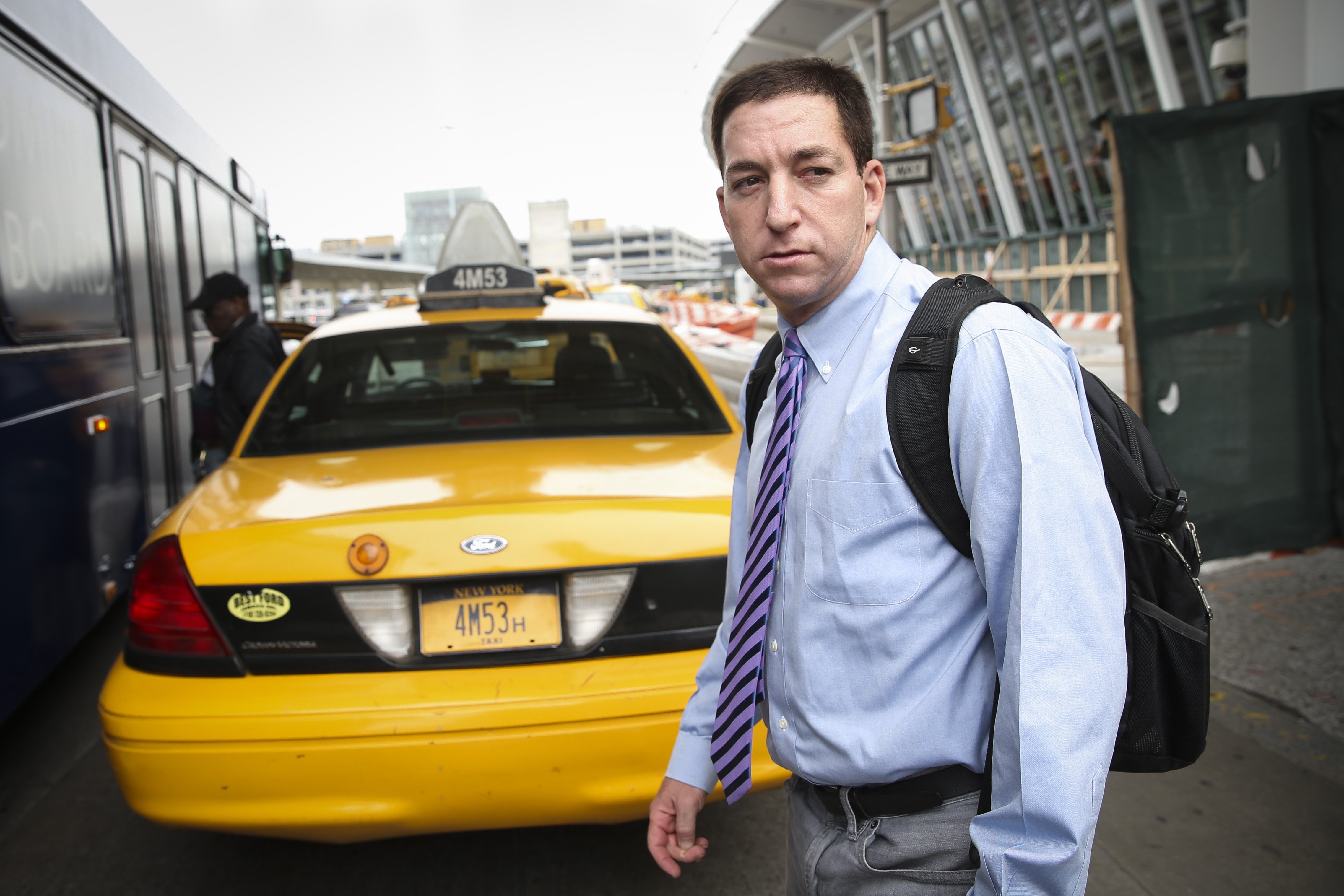 Glenn Greenwald arrives at John F. Kennedy International Airport in New York, April 11, 2014. (John Minchillo—AP)