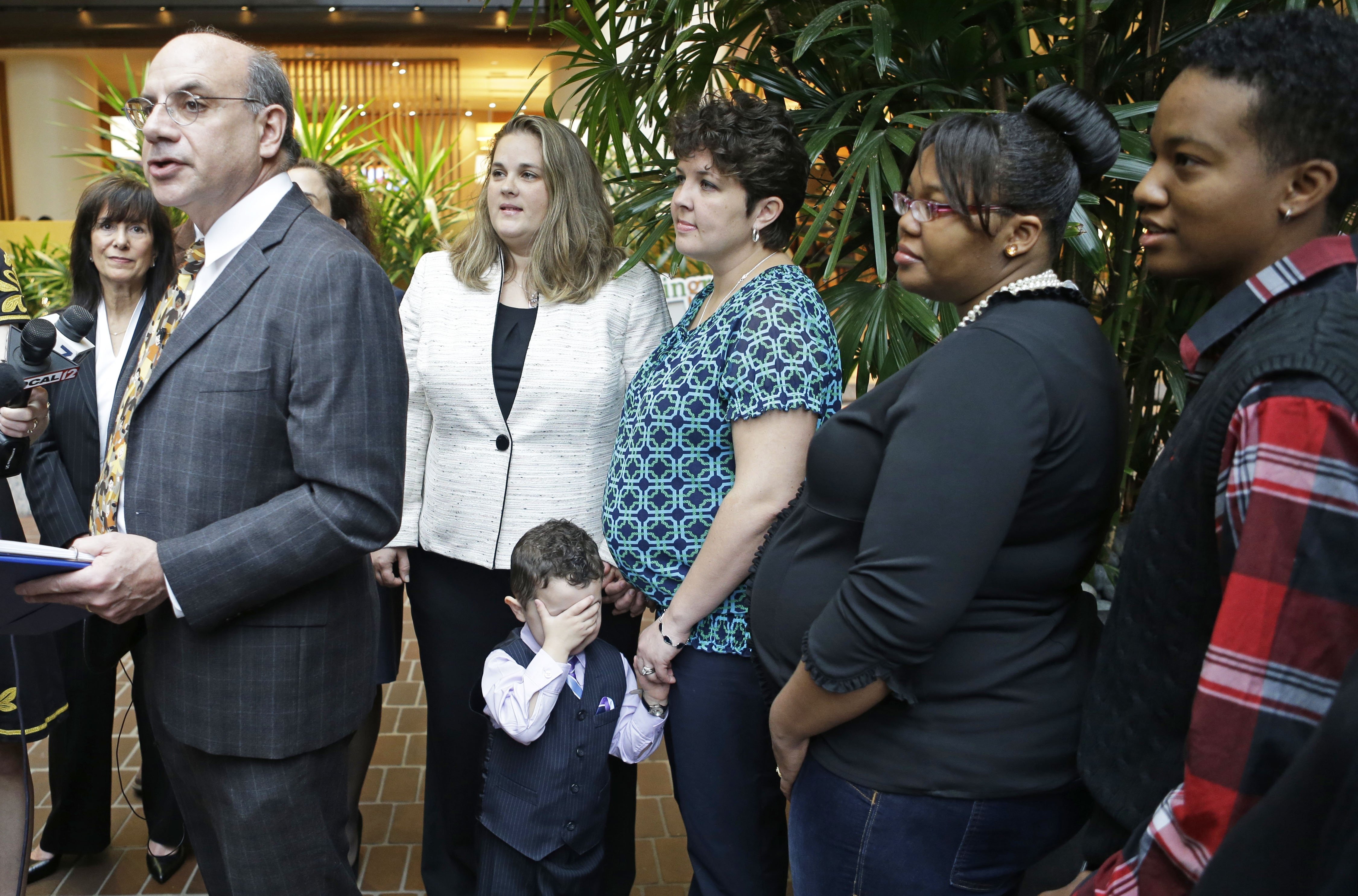 Attorney Al Gerhardstein, left, stands with several same-sex couples at a news conference, Friday, April 4, 2014, in Cincinnati. (Al Behrman—AP)