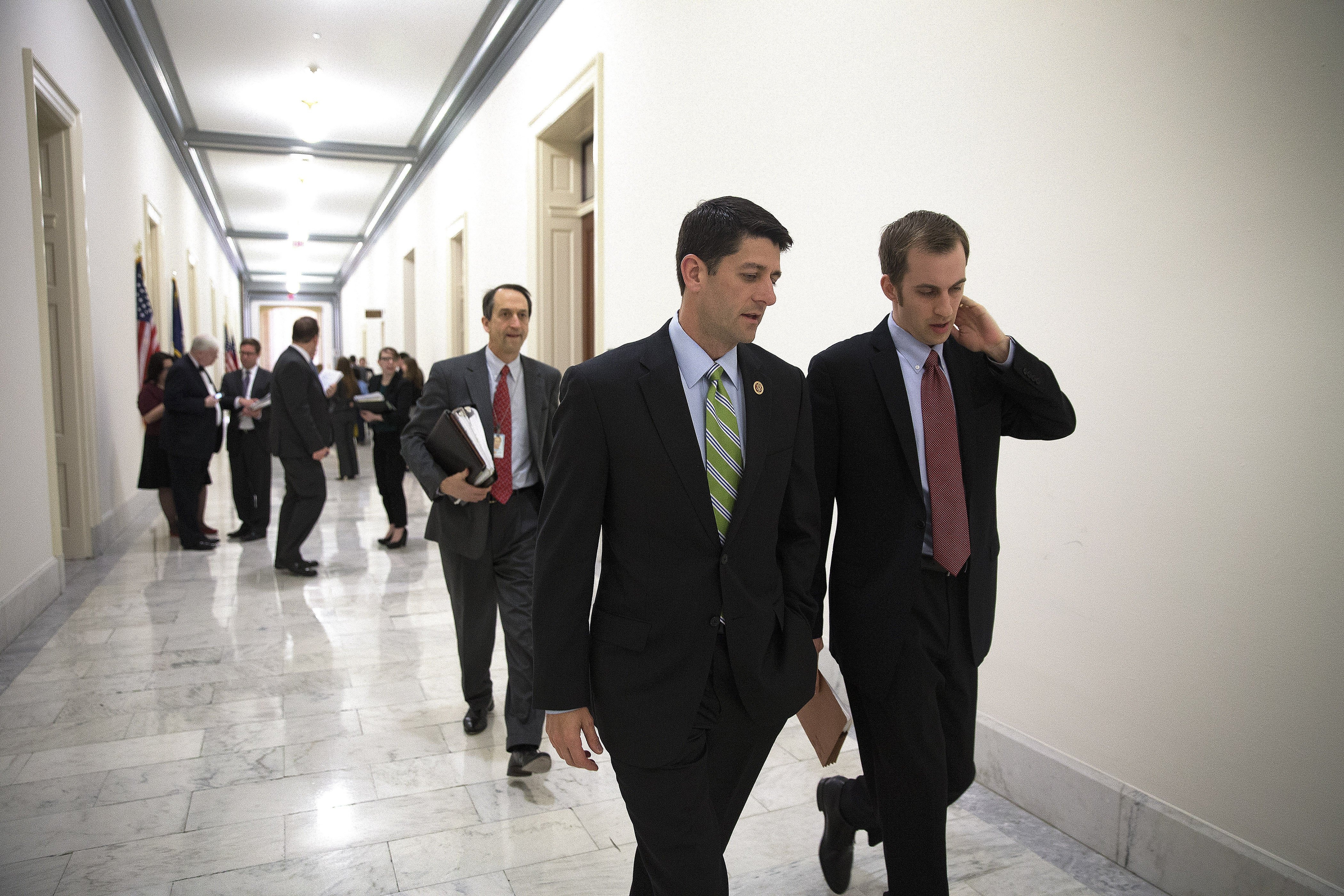 Rep. Paul Ryan, chairman of the House Budget Committee, walks with his staff following a meeting on the newest Republican budget for 2015 on Capitol Hill.