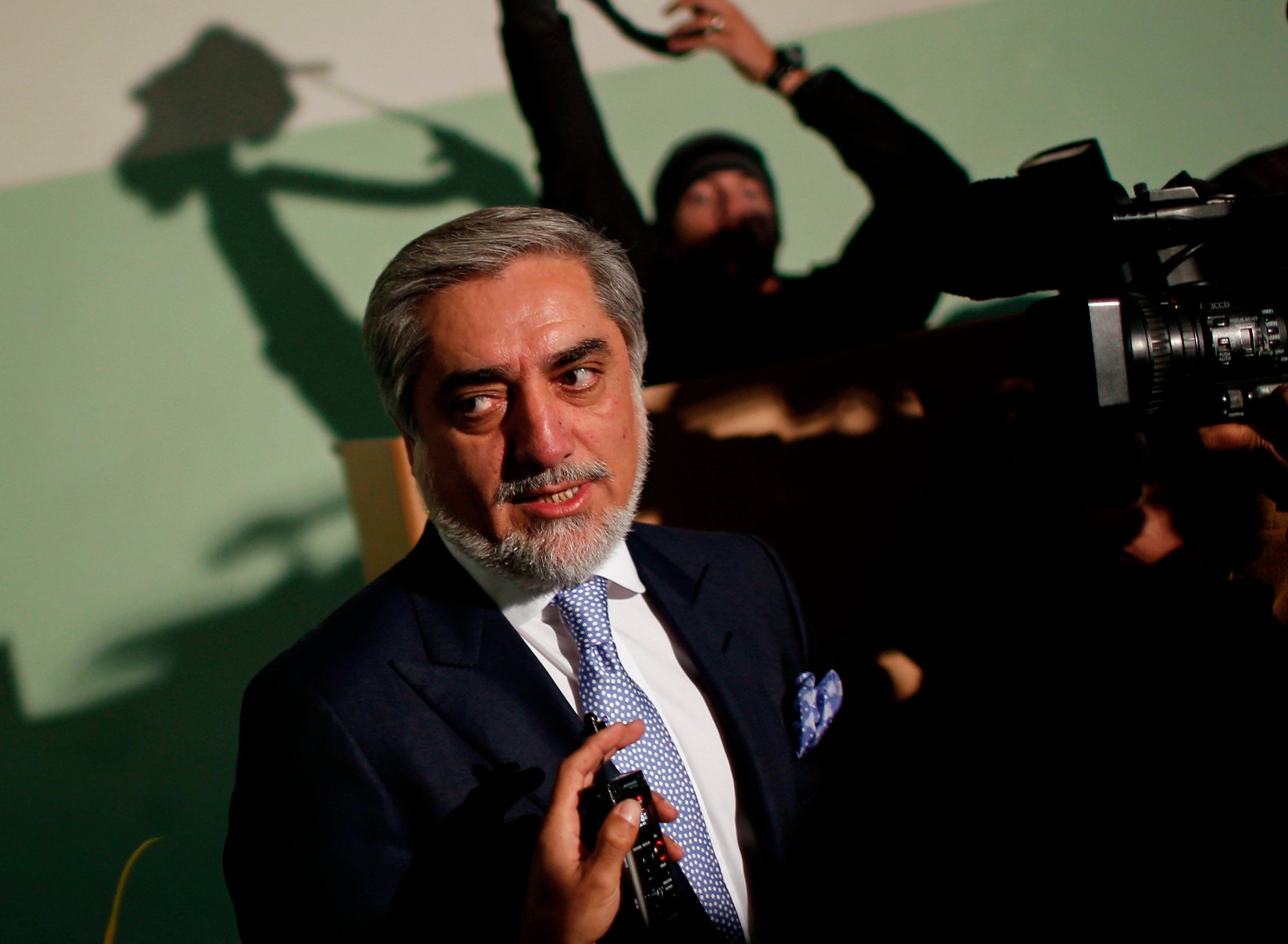 Presidential hopeful Abdullah Abdullah speaks to the media after casting his ballot