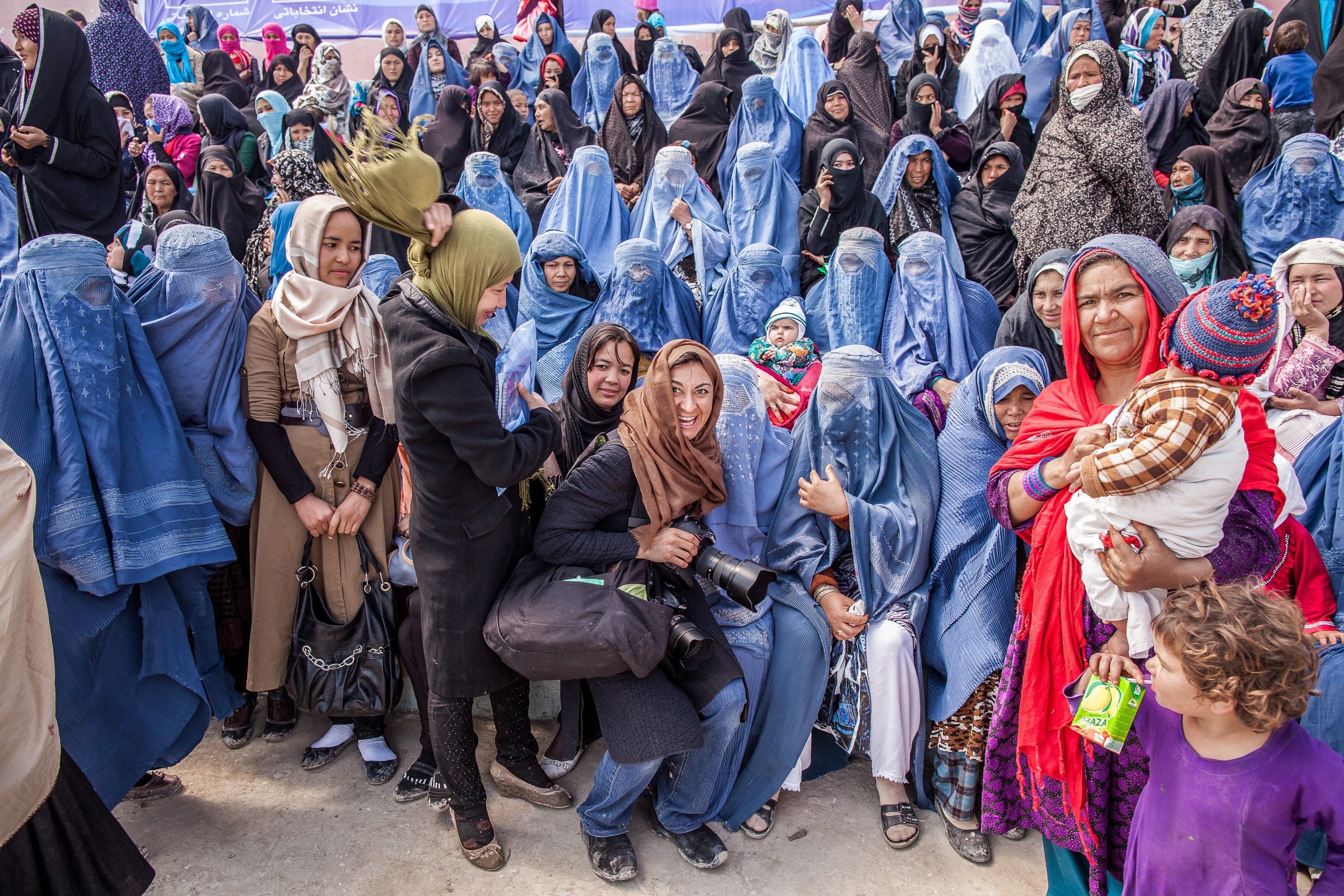 Lynsey Addario with Afghan women attending  a rally for Presidential candidate Zalmai Rassoul with Vice Presidential candidate Habiba Sarabi, in Mazar-e-Sharif, Afghanistan, March 27, 2014. (Bryan Denton—The New York Times)