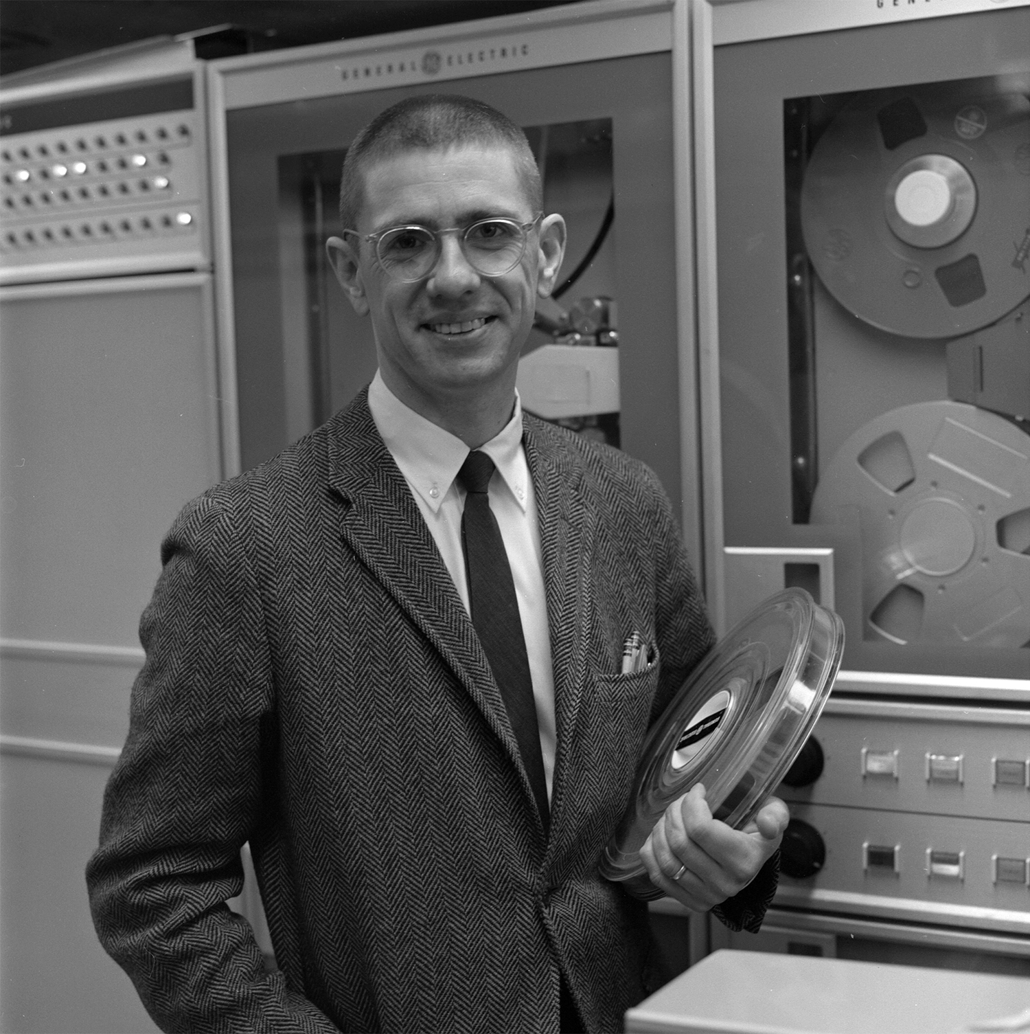 Tom Kurtz, magnetic tape in hand, poses in Dartmouth's computing center in the early days of BASIC (Adrian N. Bouchard / Dartmouth College)