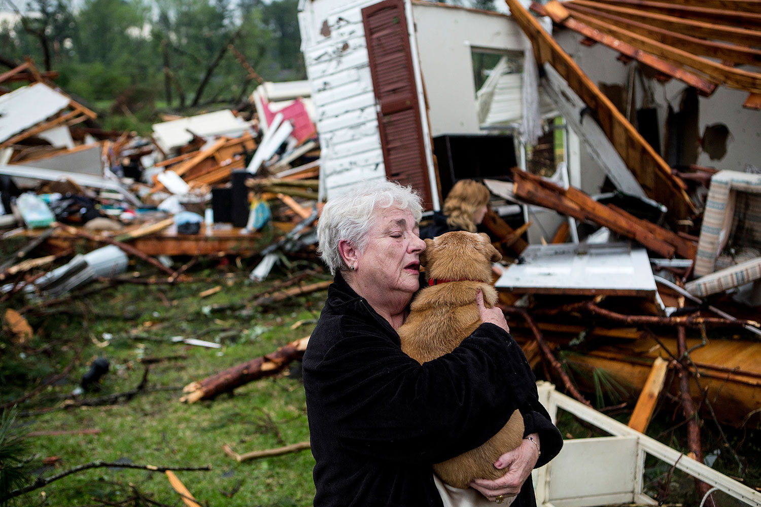 Constance Lambert embraces her dog after finding it alive when returning to her destroyed home in Tupelo, Miss., April 28, 2014. (Brad Vest—AP)