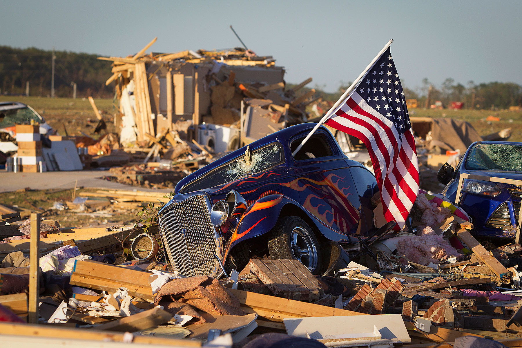 A U.S. flag sticks out the window of a damaged hot rod car in a suburban area after a tornado near Vilonia, Arkansas April 28, 2014 (Carlo Allegri—Reuters)