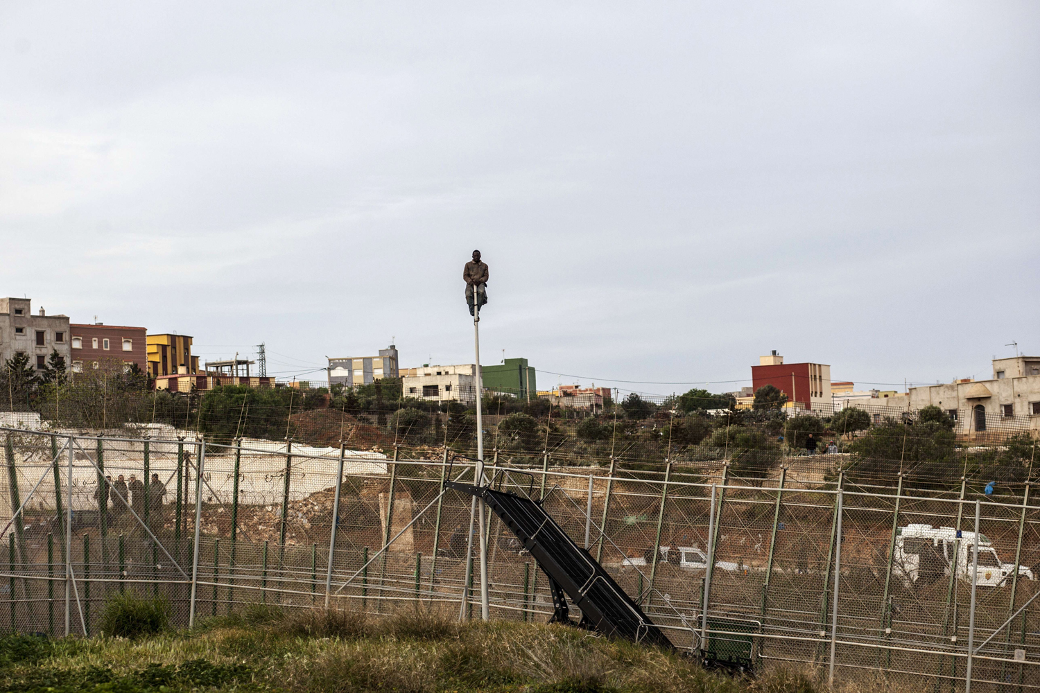 Mar. 28, 2014.
                              A would-be immigrant waits on a mast on the other side of fences near Beni Enza, into the north African Spanish enclave of Melilla.  Several hundreds people launched a dawn assault to cross into the Spanish city, which lies on the northern tip of Morocco.
