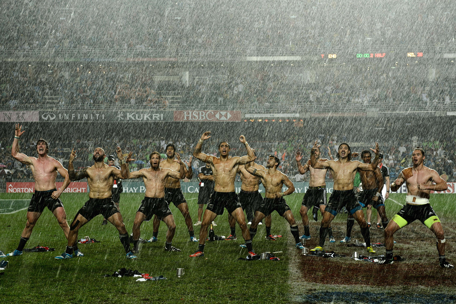 New Zealand players perform the "haka" in the rain after their victory over England in the final match on the last day of the rugby Sevens Tournament at Hong Kong Stadium March 30, 2014.
