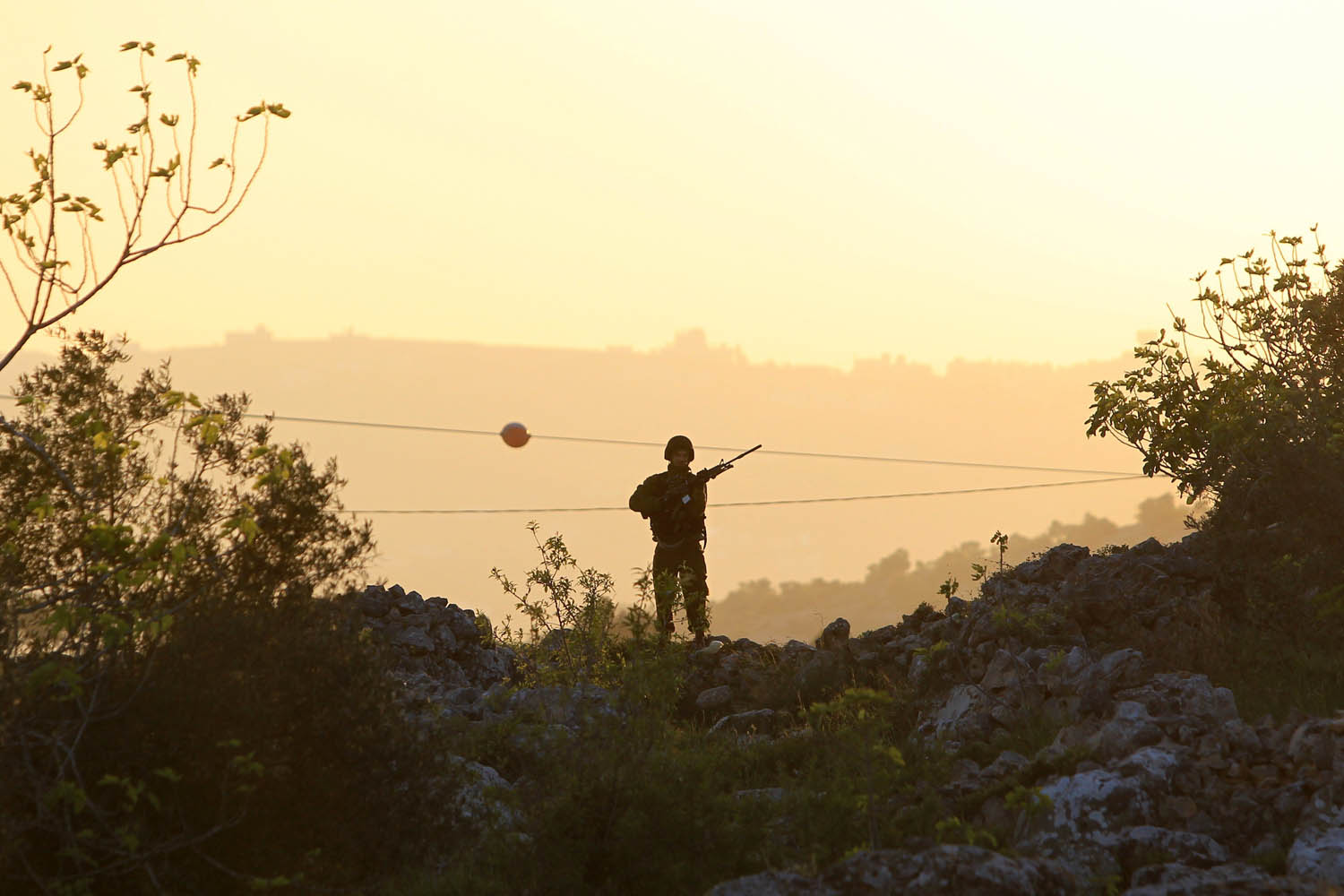Mar. 30, 2014. 
                              A member of the Israeli security force keeps watch during clashes with Palestinian protestors following a demonstration to mark Land Day, in the West Bank village of Silwad, north of Ramallah.
