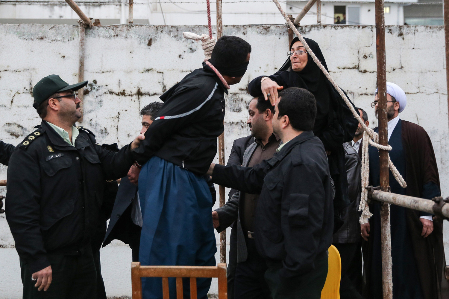 The mother (R) of Abdolah Hosseinzadeh, who was murdered in 2007, slaps Balal who killed her son during the execution ceremony in the northern city of Nowshahr on April 15, 2014 just before she removed the noose around his neck with the help of her husband, sparing the life of her son's convicted murderer.