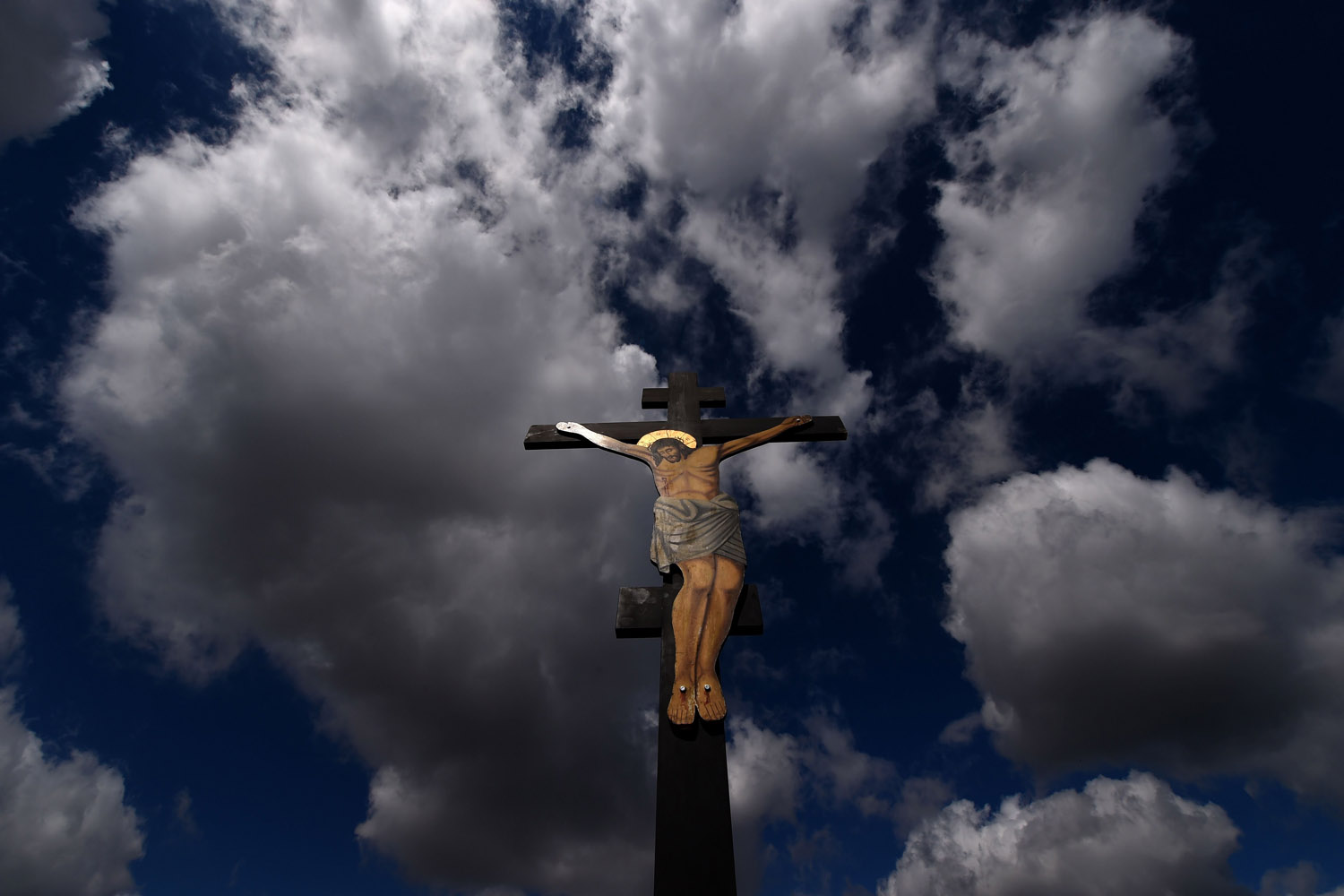 Apr. 18, 2014. An image of Jesus crucified stands at a hill during the ceremony marking the Apokathelosis, the removal of Christ's body from the Cross, which forms a key part of Orthodox Easter, in a ceremony at the Church of the Dormition of the Virgin in Penteli, north of Athens.