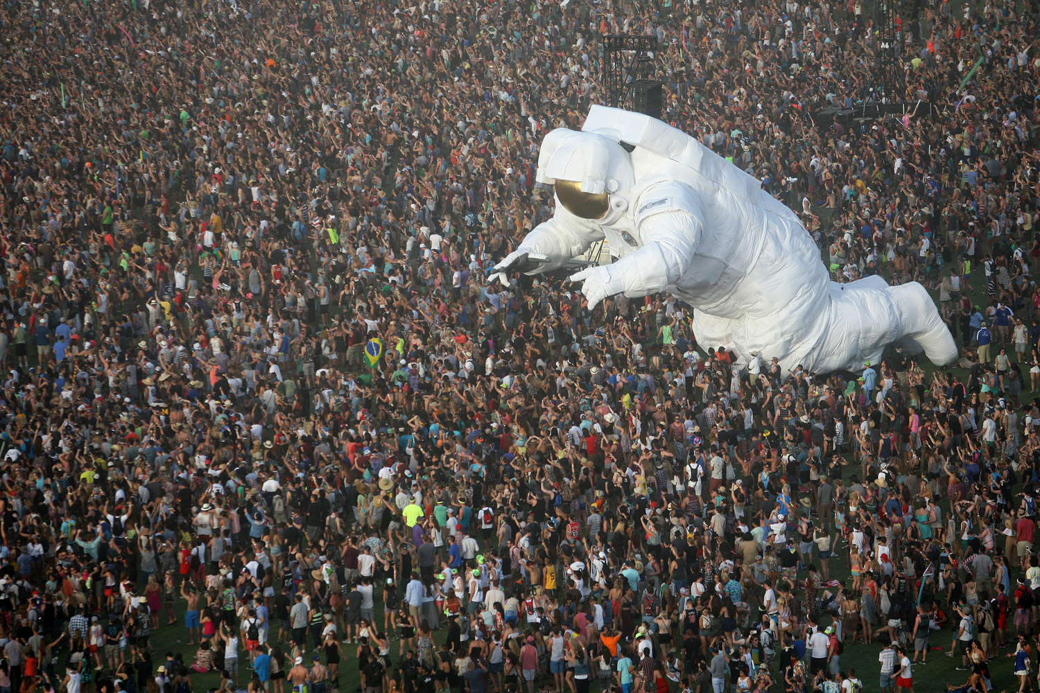The giant moving inflated astronaut art piece, Escape Velocity, is surrounded by music fans at the Coachella Valley Music &amp; Arts Festival at the Empire Polo Club in Indio, California, April 12, 2014.