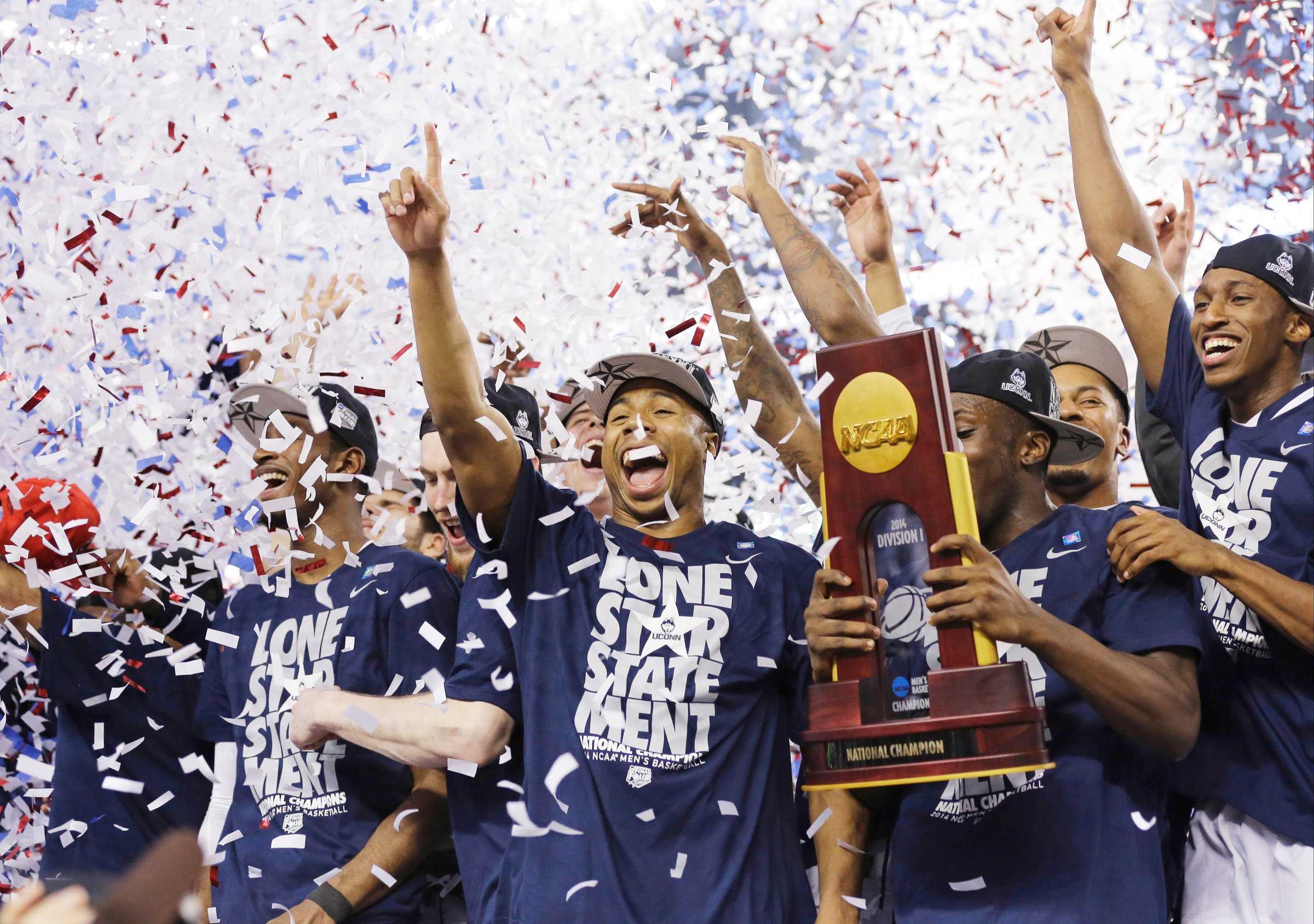 Connecticut celebrates with the championship trophy after beating Kentucky 60-54 at the NCAA Final Four tournament college basketball championship game on April 7, 2014, in Arlington, Texas.