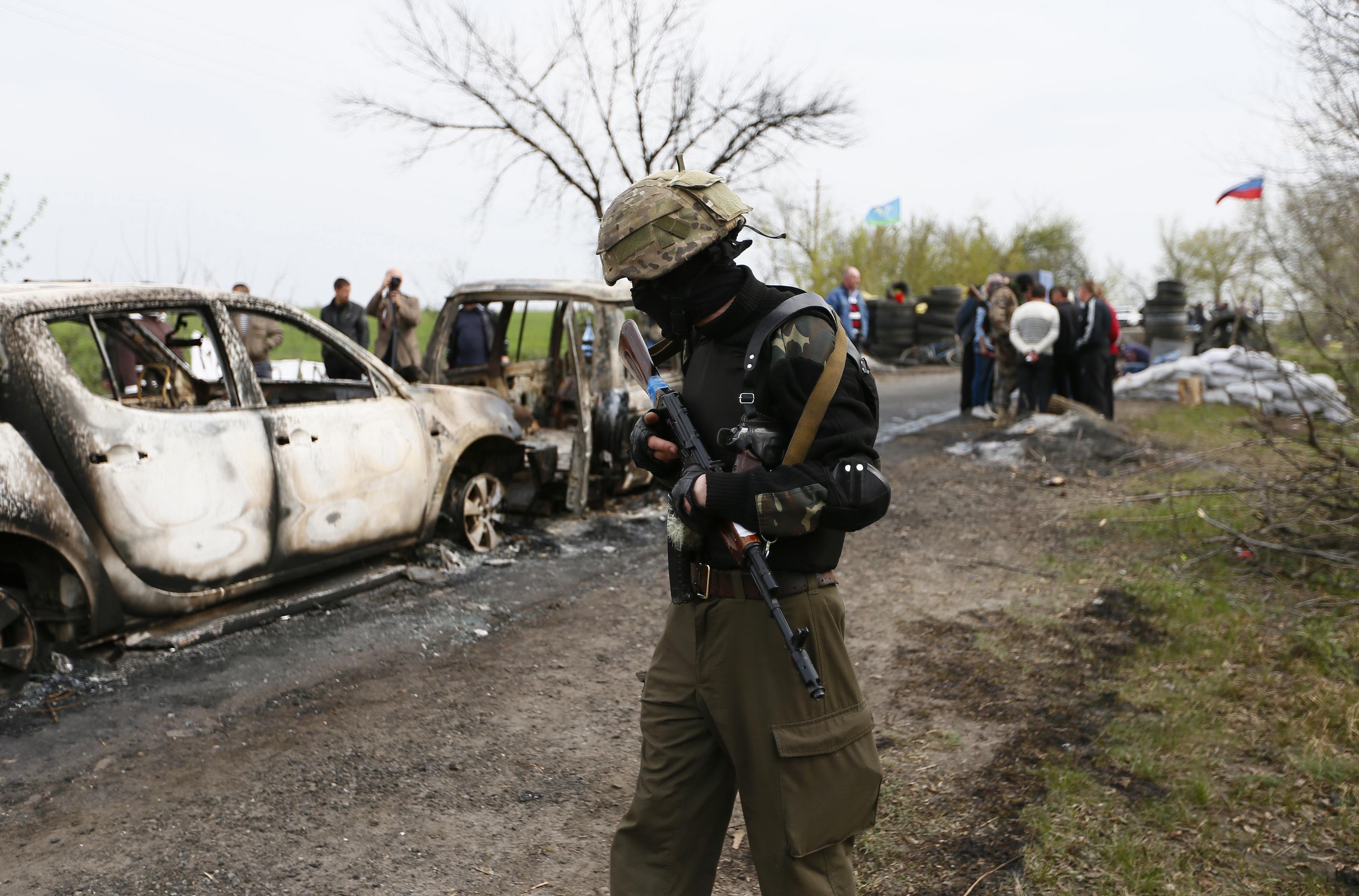 Pro-RussaA Pro-Russian militant walks near a checkpoint that was the scene of a gunfight overnight near the city of Slaviansk, April 20, 2014.ian militant walks near a checkpoint which was the scene of a gunfight overnight near the city of Slaviansk