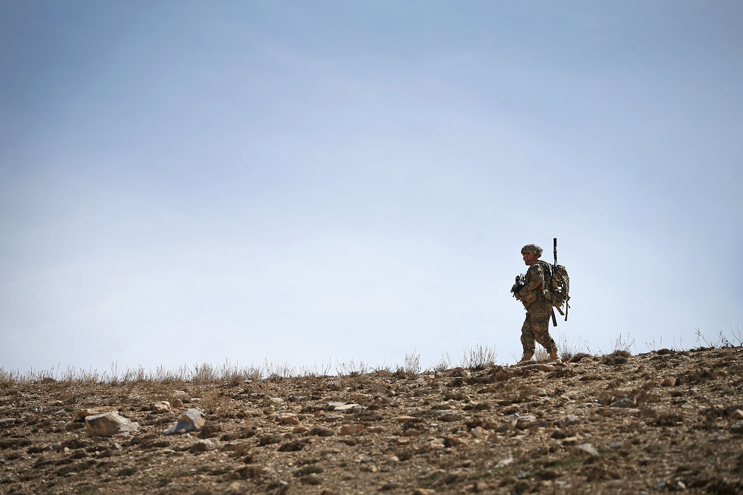 U.S. soldier walks along a ridgeline during a patrol up a mountainside near Forward Operating Base Shank on March 31, 2014 near Pul-e Alam, Afghanistan. (Scott Olson—Getty Images)