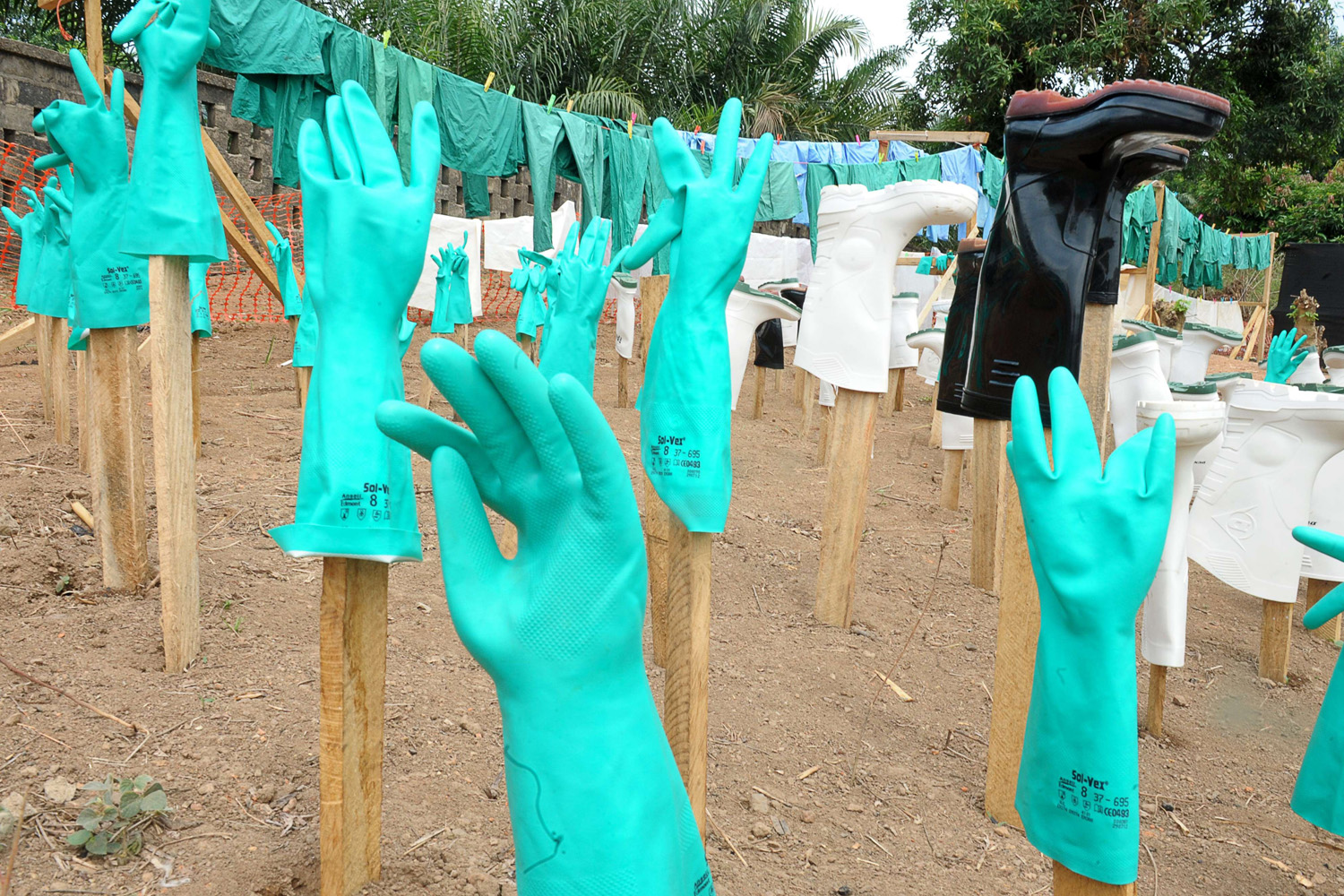 A view of gloves and boots used by medical staff, drying in the sun, at a center for victims of the Ebola virus in Guekedou, on April 1, 2014.