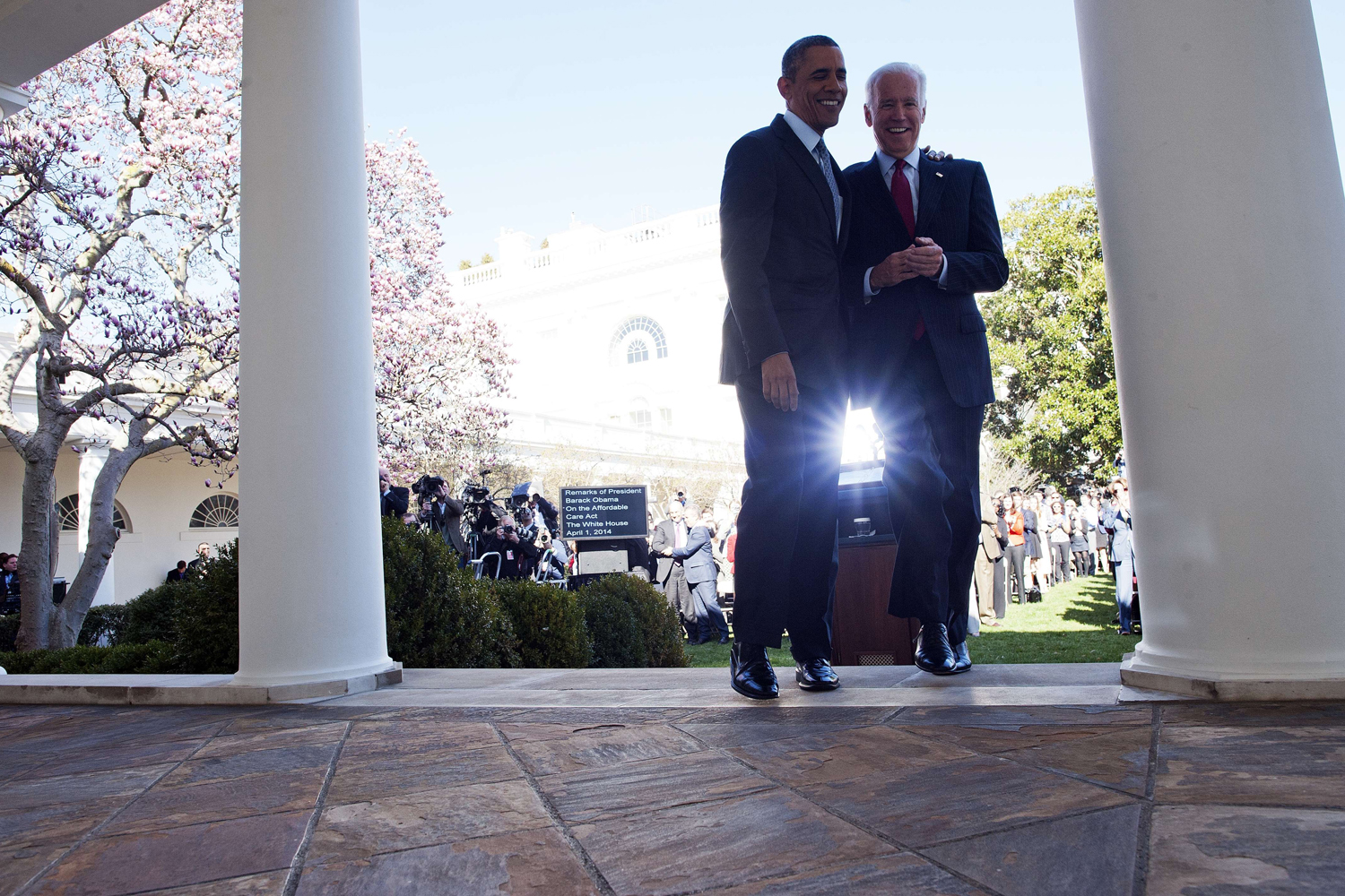 U.S. President Barack Obama walks back to the Oval Office with Vice President Joe Biden after he delivered a statement on the Affordable Care Act at the Rose Garden of the White House in Washington, DC, on April 1, 2014.
