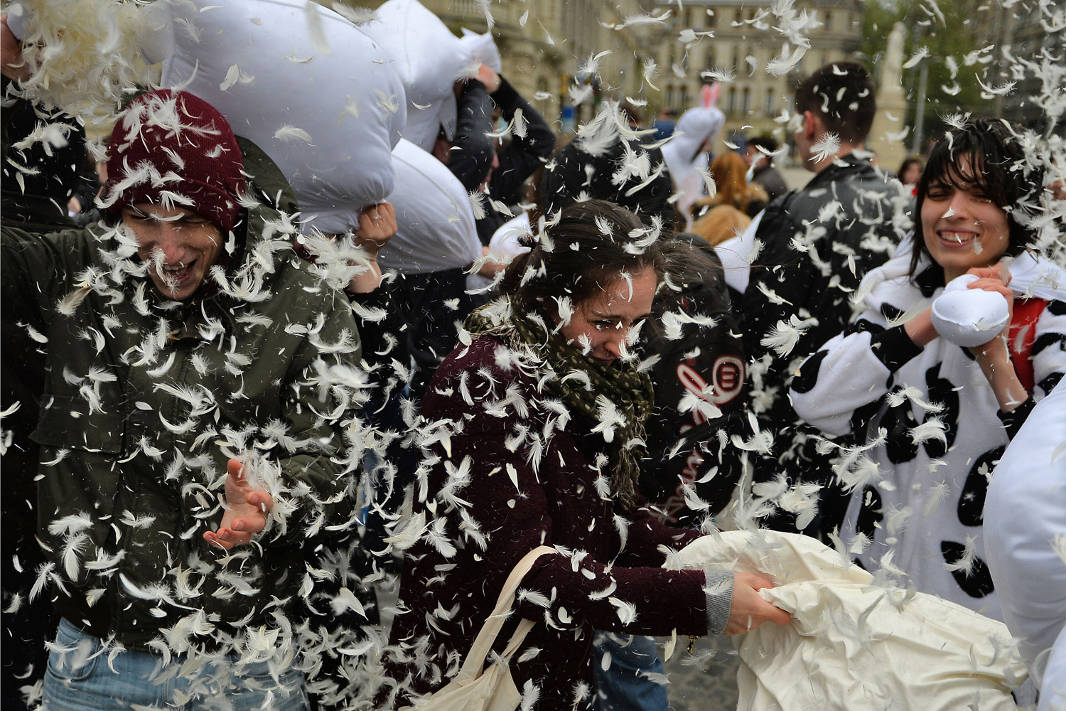 People fight with pillows at the University's Square on World Pillow Fight Day 2014 in Bucharest on April 5, 2014.