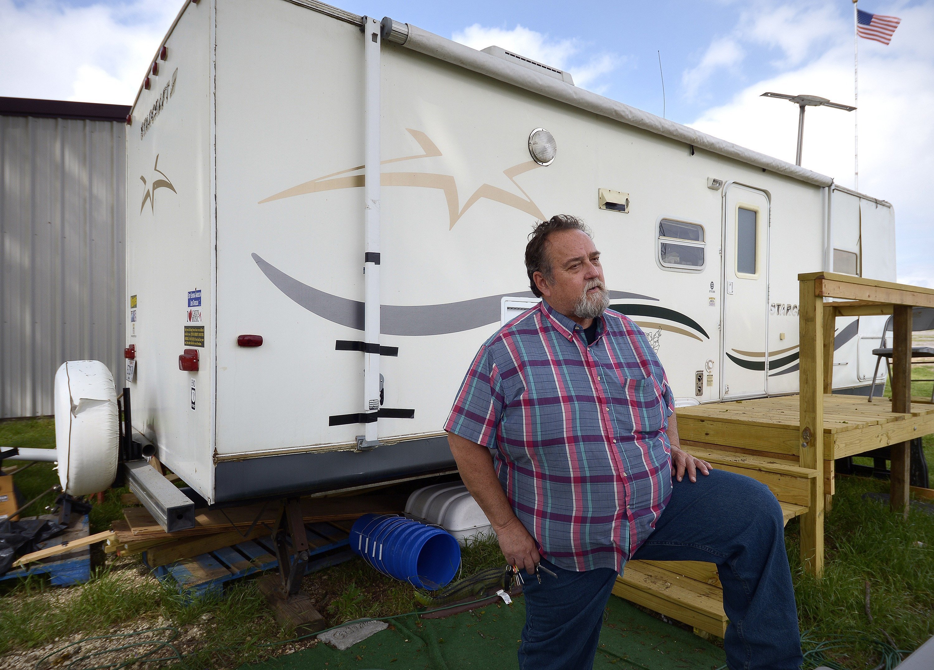 John Raimer stands in front of his trailer that he lives in as he leads at the West Long Term Recovery team in West, Texas, on April 1, 2014.