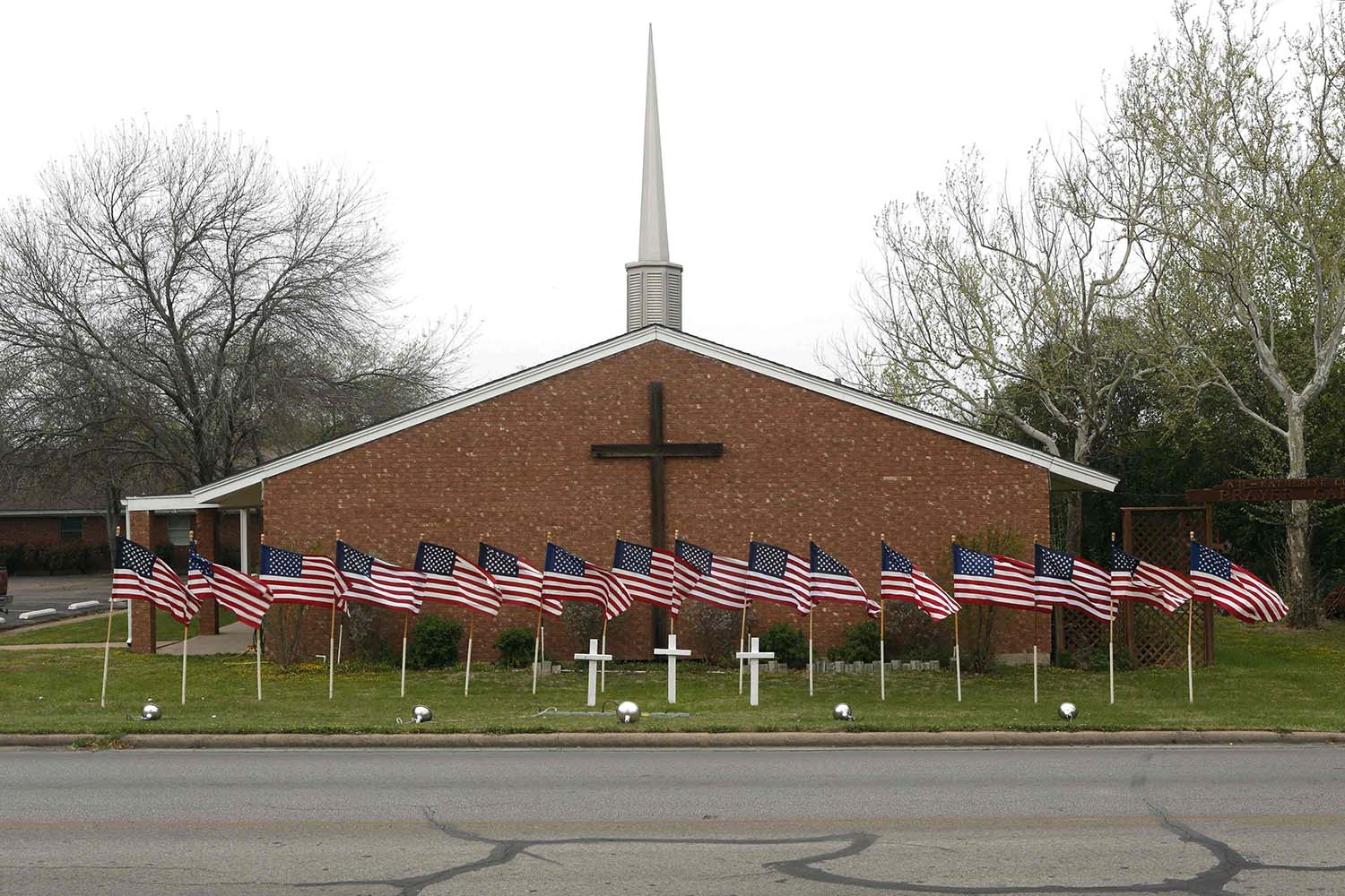 Apr. 3, 2014. U.S. flags are pictured in front of the Central Christian Church in Killeen, Texas where the Fort Hood Army Base is located. The commander of the base on Thursday identified the soldier suspected of shooting dead three people and wounding 16 on Wednesday as Ivan Lopez, 34.