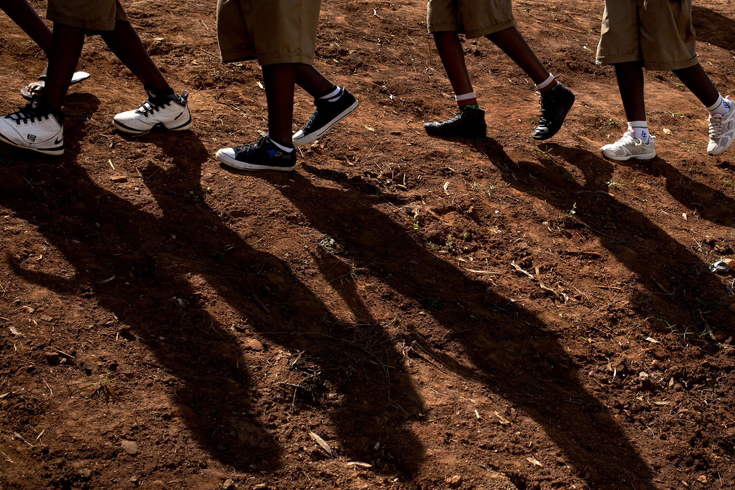 Apr. 3, 2014. Rwandan children walk to watch a torch ceremony as hundreds gather to await the arrival of a small flame of remembrance, symbolic fire traveling the country, and hear genocide memories, at the Petit Seminaire school in Ndera, east of the capital Kigali, in Rwanda.