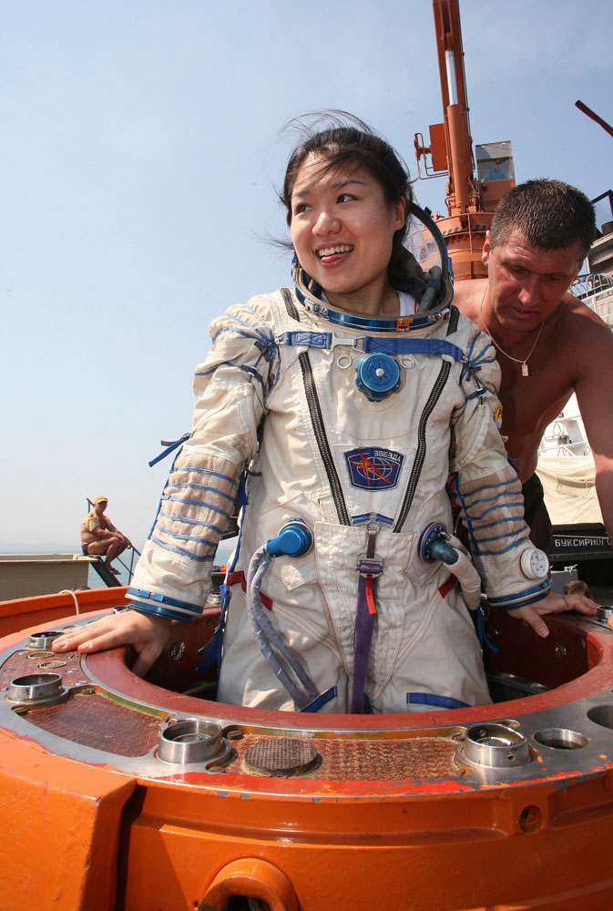 South Korea's first woman in space, astronaut Yi So-yeon is helped by Russian specialists as she undergoes a splashdown landing training session in the Ukrainian Black Sea city of Sevastopol, on July 24, 2007.