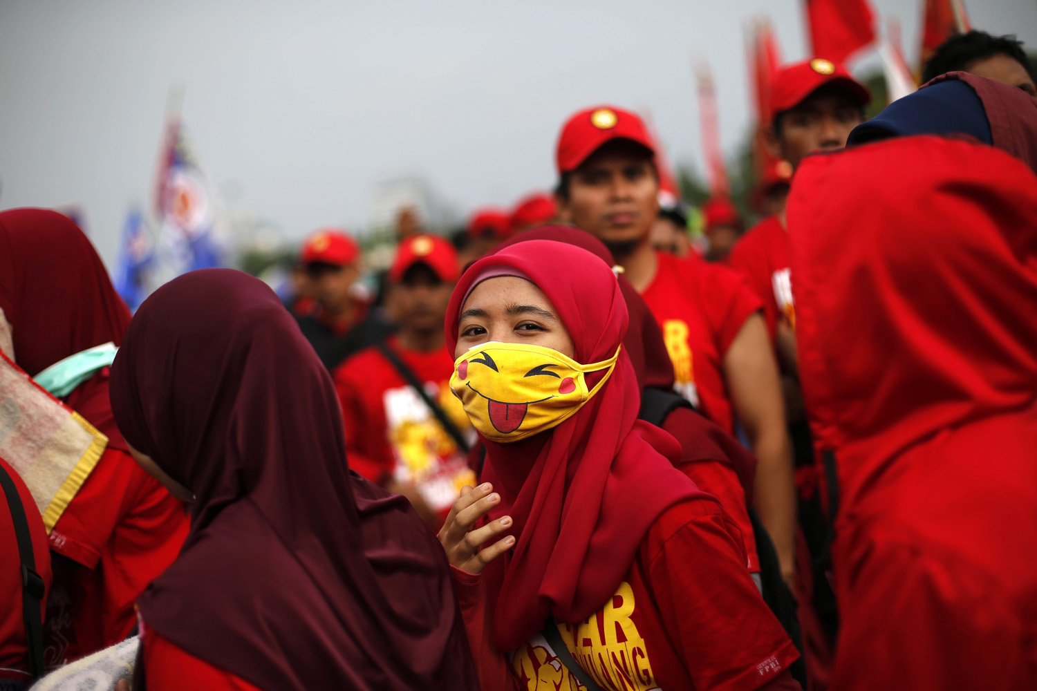 May 1, 2014. An Indonesian worker wears a pikachu Japanese character mask during a rally to mark the International Labor Day outside the presidential palace in Jakarta, Indonesia. (Nick Ut—AP)
