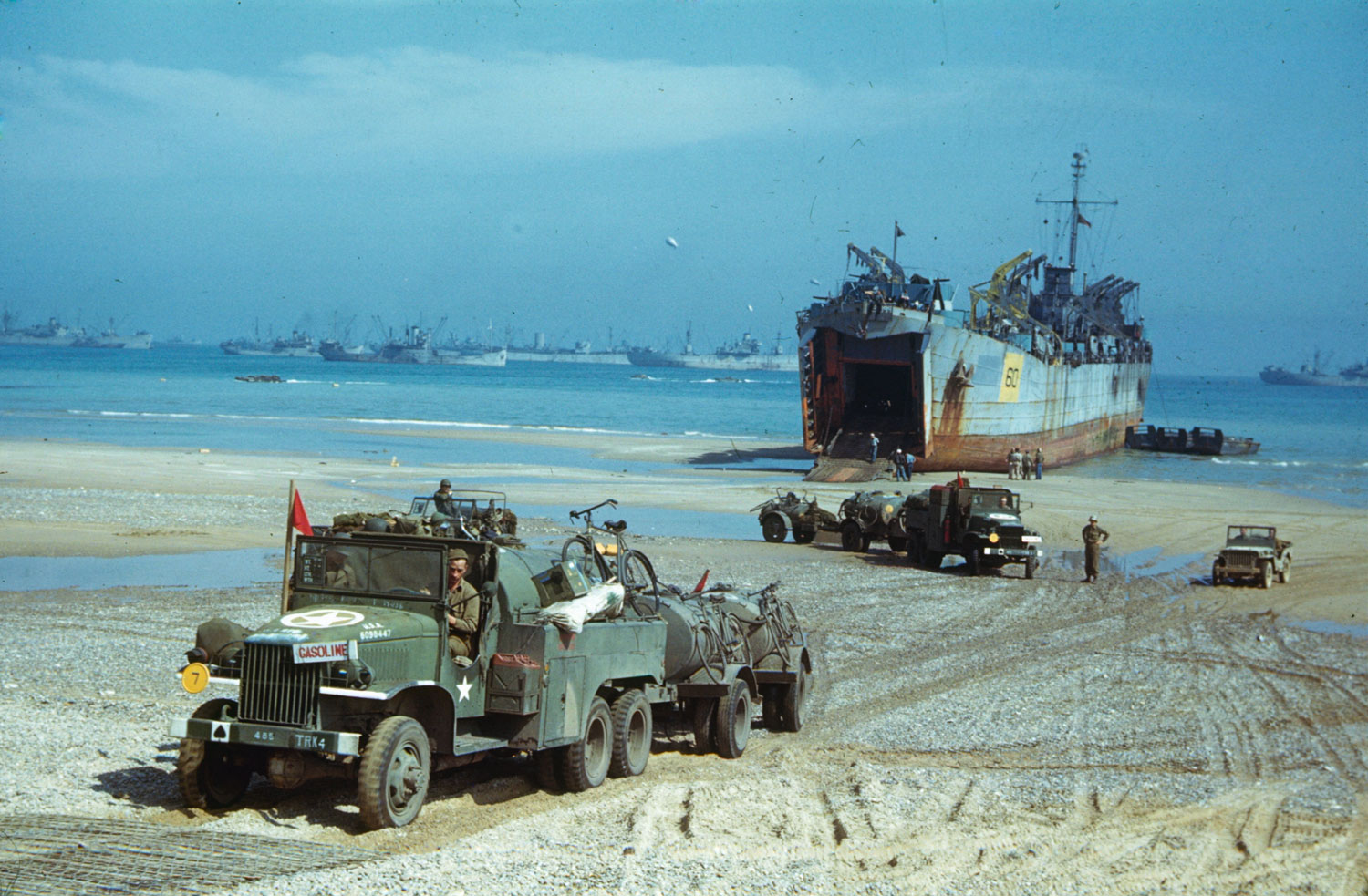 Unloading vehicles and supplies from an LST (landing ship, tank) at Normandy beachhead, summer 1944.
