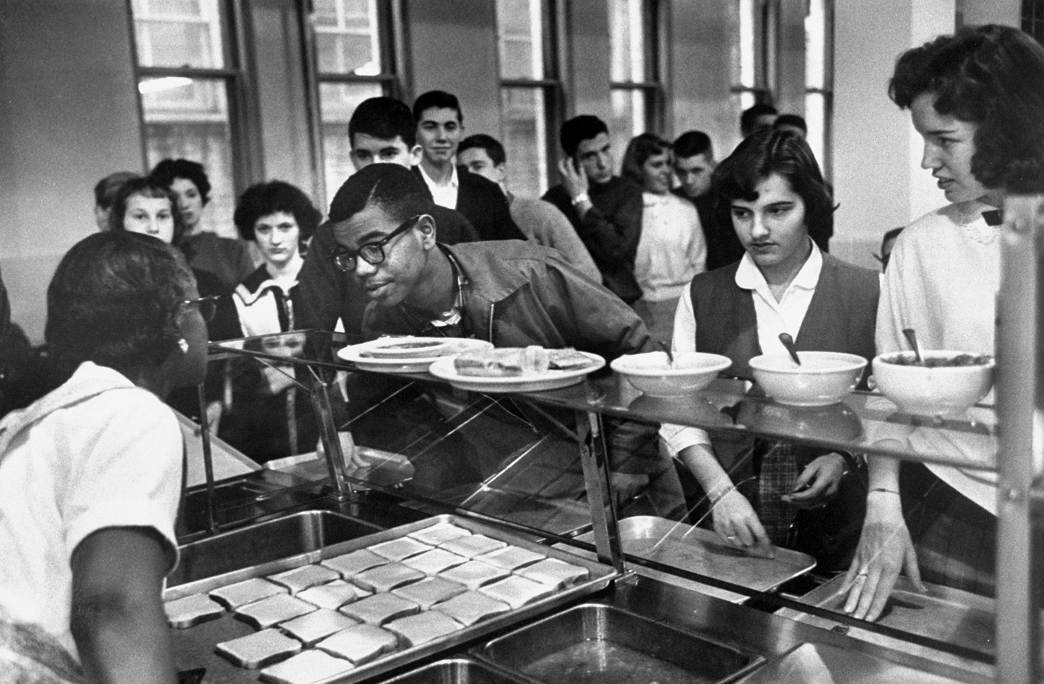 Louis Cousins orders lunch in cafeteria at newly desegregated Maury high school, Norfolk, Va., 1959.