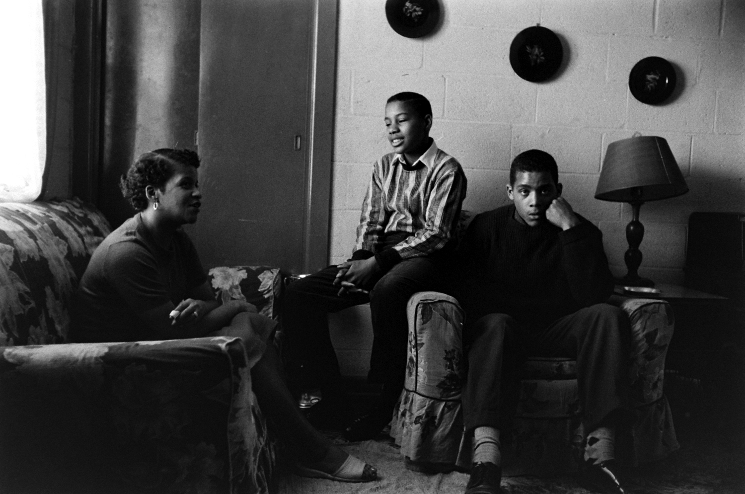 Alveraze "Freddy" Gonsouland (hand on cheek) at home with his half-brother and mother, Norfolk, Va., 1959.