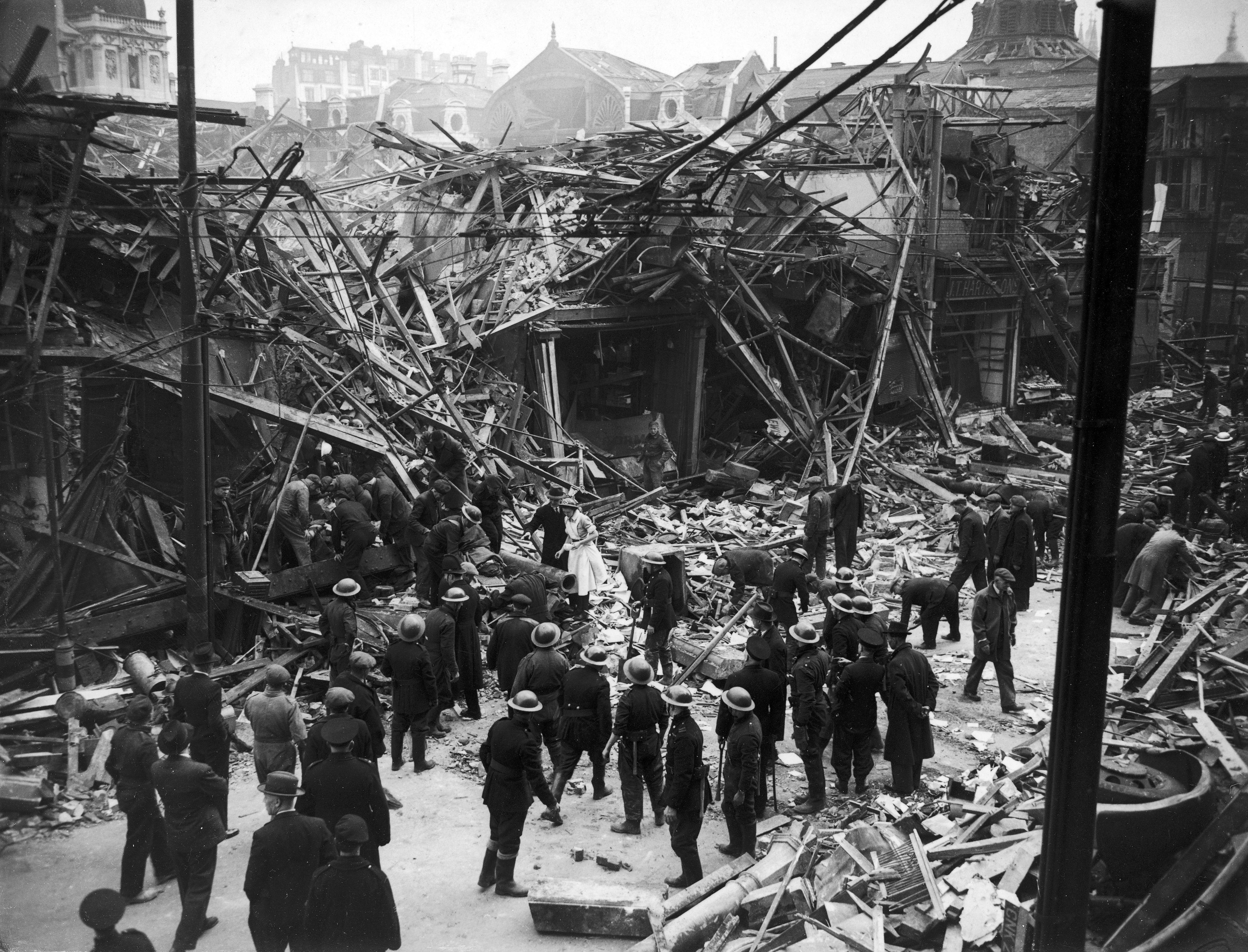 Rescue workers help pull victims from ruins of a building hit by a German V-1  flying bomb  rocket, July 1944.