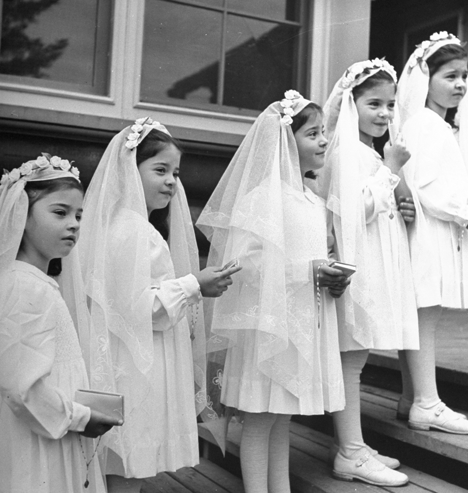 A view of the "Dionne Quintuplets" posing in their confirmation dresses on day of their first Holy Communion, 1940.