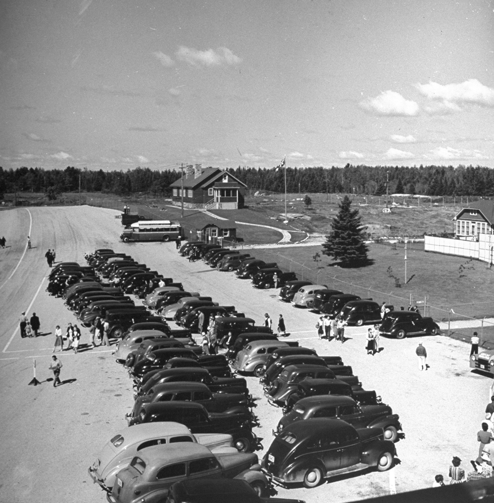 Tourists pulling up to visit the home of the Dionne Quintuplets, Canada, 1940.