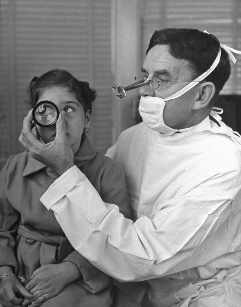 Marie's eyes are examined by Dr. William Hill of Toronto. Her left eye showed improvement, her weaker eye none. She will need glasses