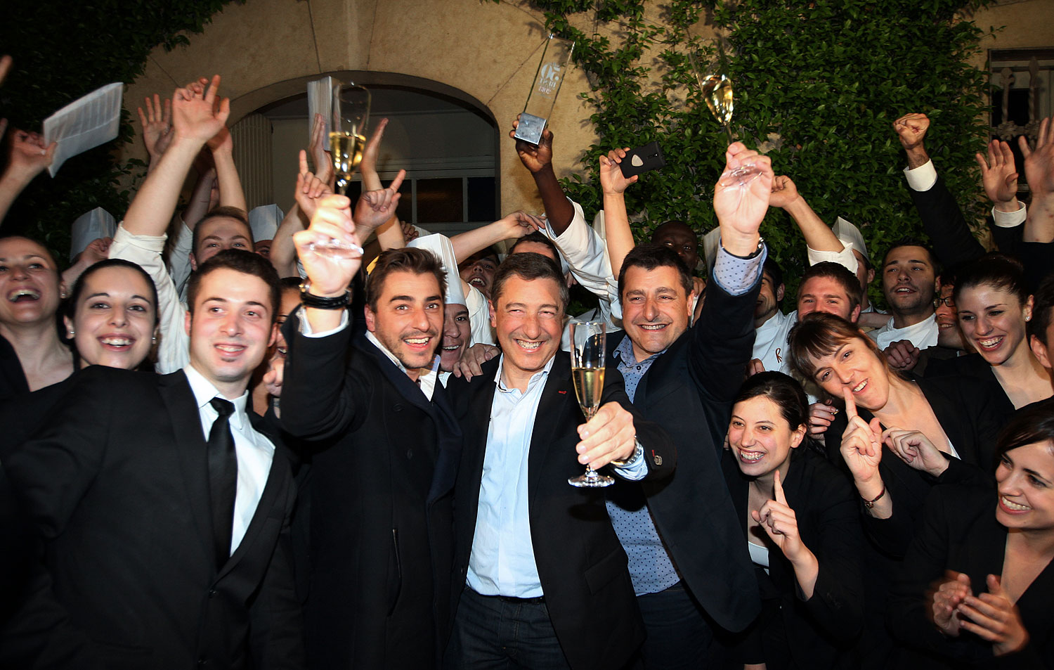 Spanish Chefs of "El Celler de Can Roca" Joan Roca, center, Jordi Roca, left, and Josep Roca, right, pose with their employees at the restaurant in Girona on April 30, 2013. (Quique Garcia—AFP/Getty Images)