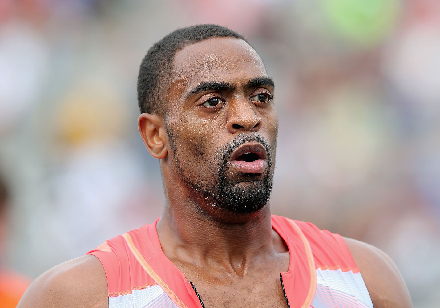 Tyson Gay, Olympic sprinter, smiling and wearing a USA track suit